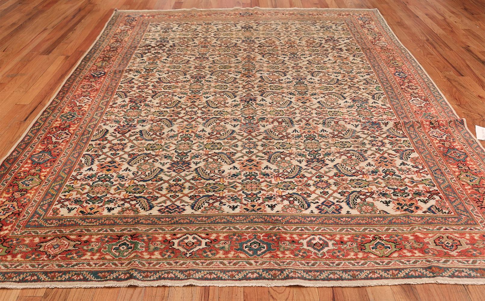 Antique Sultanabad carpet, Origin: Persia, circa 1920 -- Size: 8 ft x 10 ft 7 in (2.44 m x 3.23 m). 

The delightful display of colors and floral shapes in this Sultanabad rug create an almost living, breathing universe for the viewer to explore.