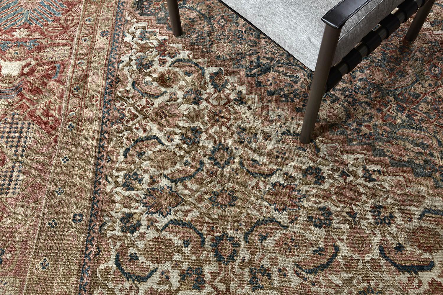 This carpet features the well-known Herati design with central diamond flanked by flower heads and leaves, superimposed on a multicolored background. The lattice border is framed in this area. A brilliant creation made it to the square rug to be one