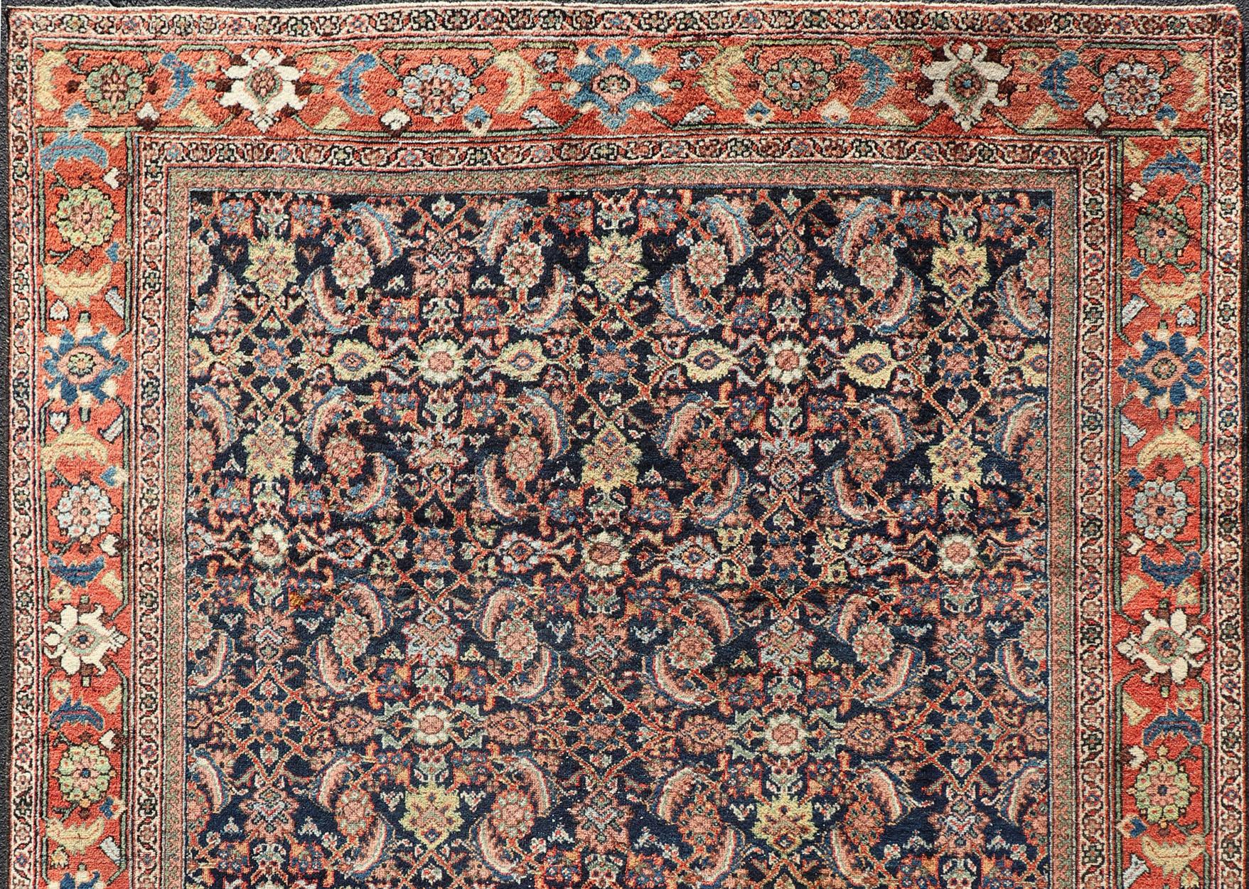 Antique Persian Sultanabad rug in blue background in multi colors. rug R20-0802, country of origin / type: Iran / Sultanabad, circa 1910. 

This antique Persian Sultanabad-mahal rug features an all over Herati pattern with the coloration
