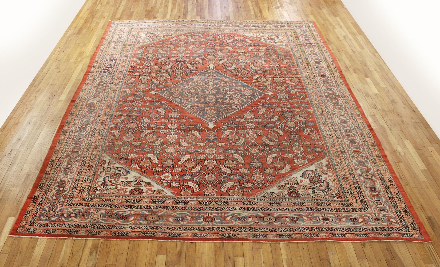 Antique Persian Sultanabad Rug, Room size, circa 1900

A one-of-a-kind antique Persian Sultanabad oriental carpet, hand-knotted with short wool pile. This lovely hand-knotted carpet features a central medallion on a coral primary field, with a light
