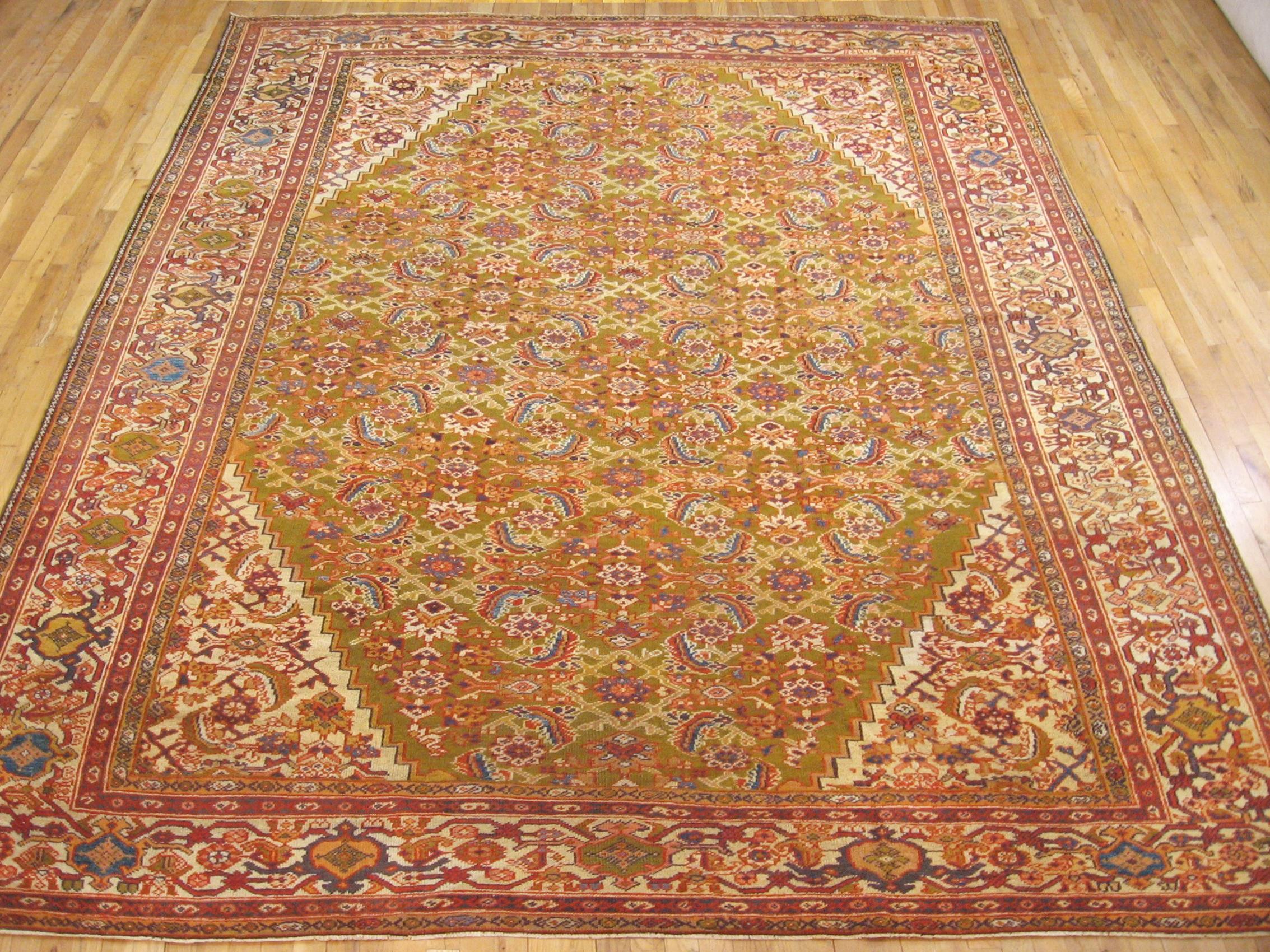 Antique Persian Sultanabad rug, room size, circa 1910.

A one-of-a-kind antique Persian Sultanabad oriental carpet with a thick and lustrous wool pile, knotted by hand, with soft touch and great resistance to wear. This lovely carpet features an