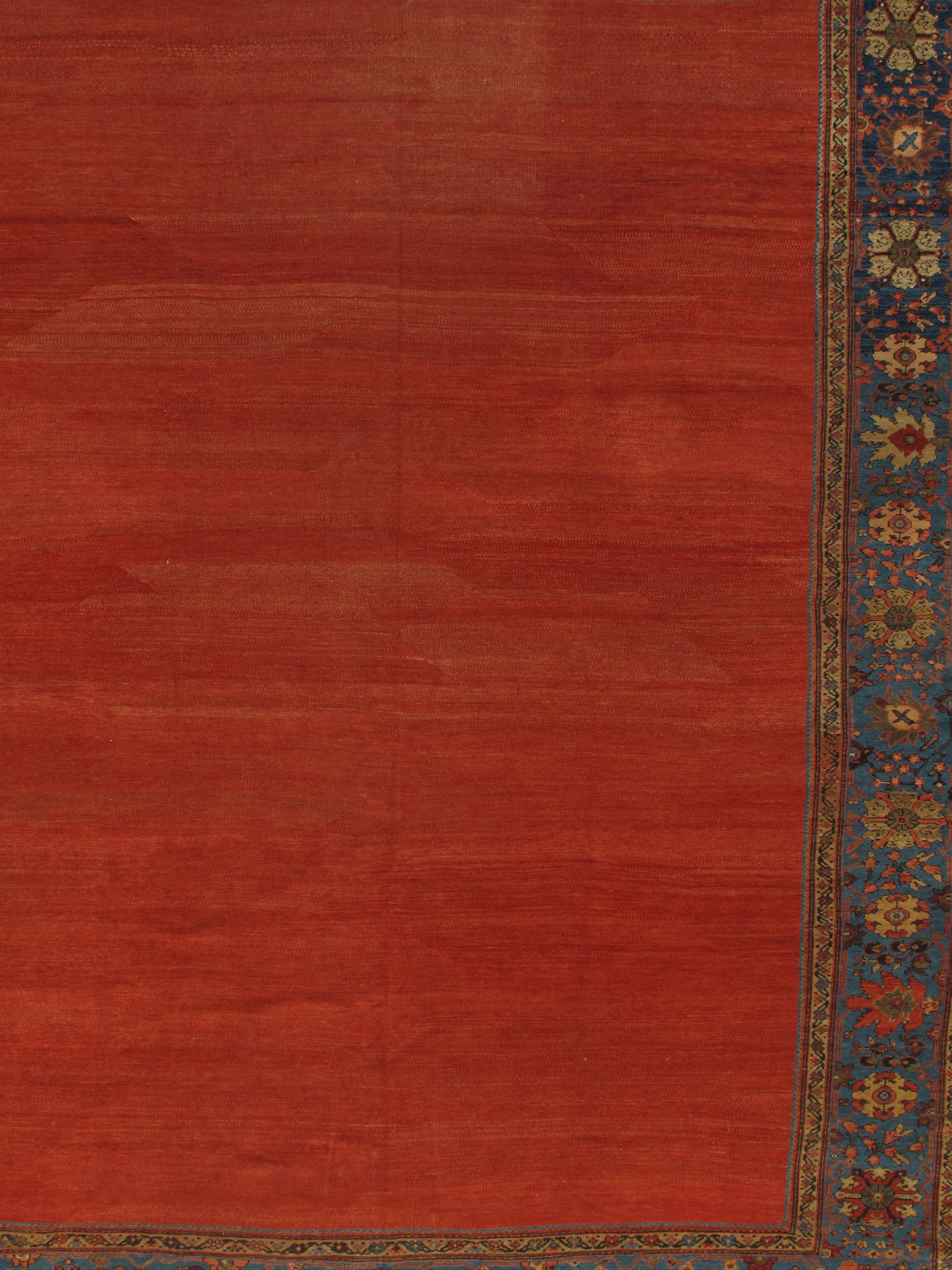 Antique Persian Sultanabad Rug 9'10 x 13'4. This antique Sultanabad has a plain red ground surrounded by a main border in soft blues and filled with wonderful floral motifs, circa 1880. The rug has a natural light and dark side and the pictures