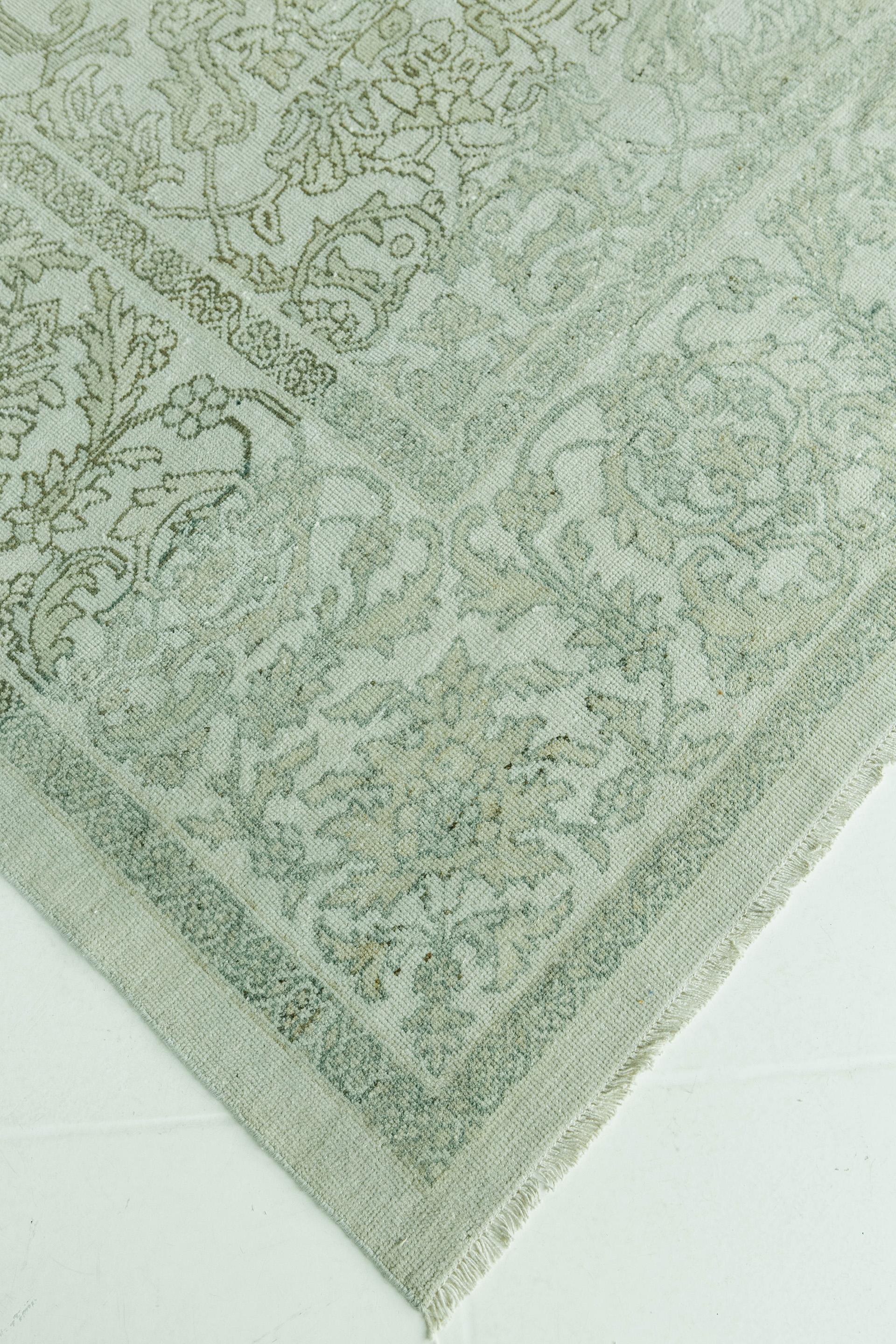 This silvery gray-field antique Sultanabad features vine and palmette motifs with densely floreated medallion, pendant and corner-pieces. Secondary colors include taupe with darker gray and umber outline. The border is an intricate and large scale