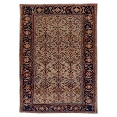 Tapis persan ancien de Sultanabad, champ ivoire, bordures bleu marine foncé, vers 1900