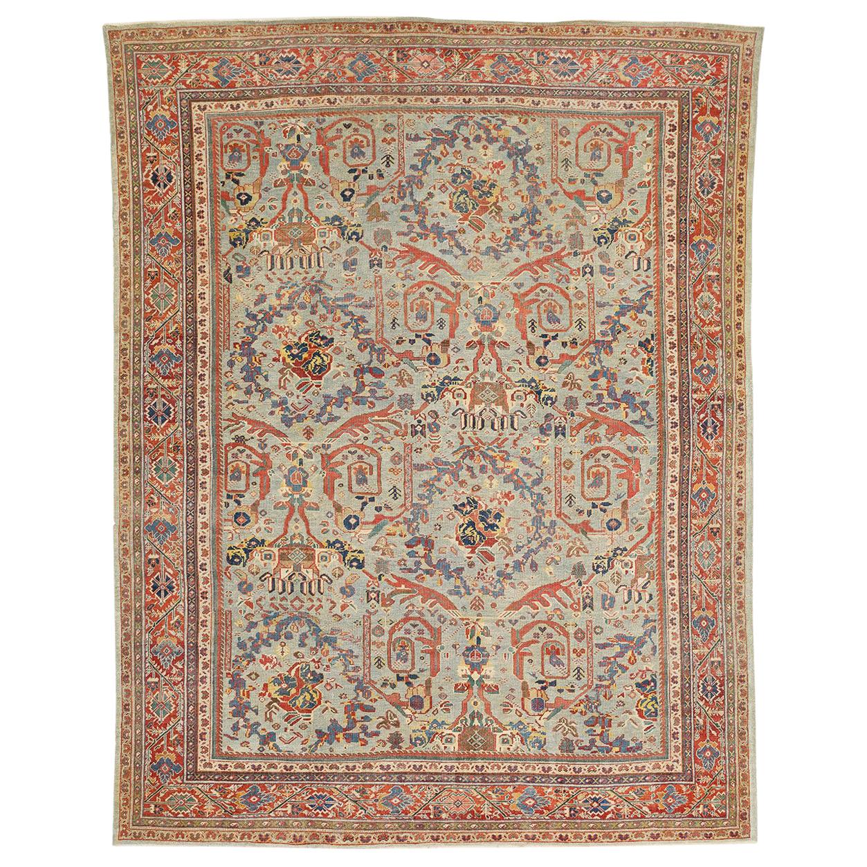 Antique Persian Sultanabad Rug with Blue and Red Botanical Motifs For Sale