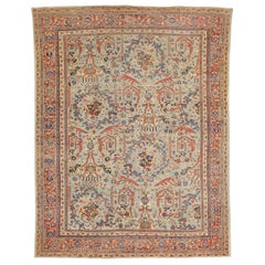 Antique Persian Sultanabad Rug with Blue and Red Botanical Motifs