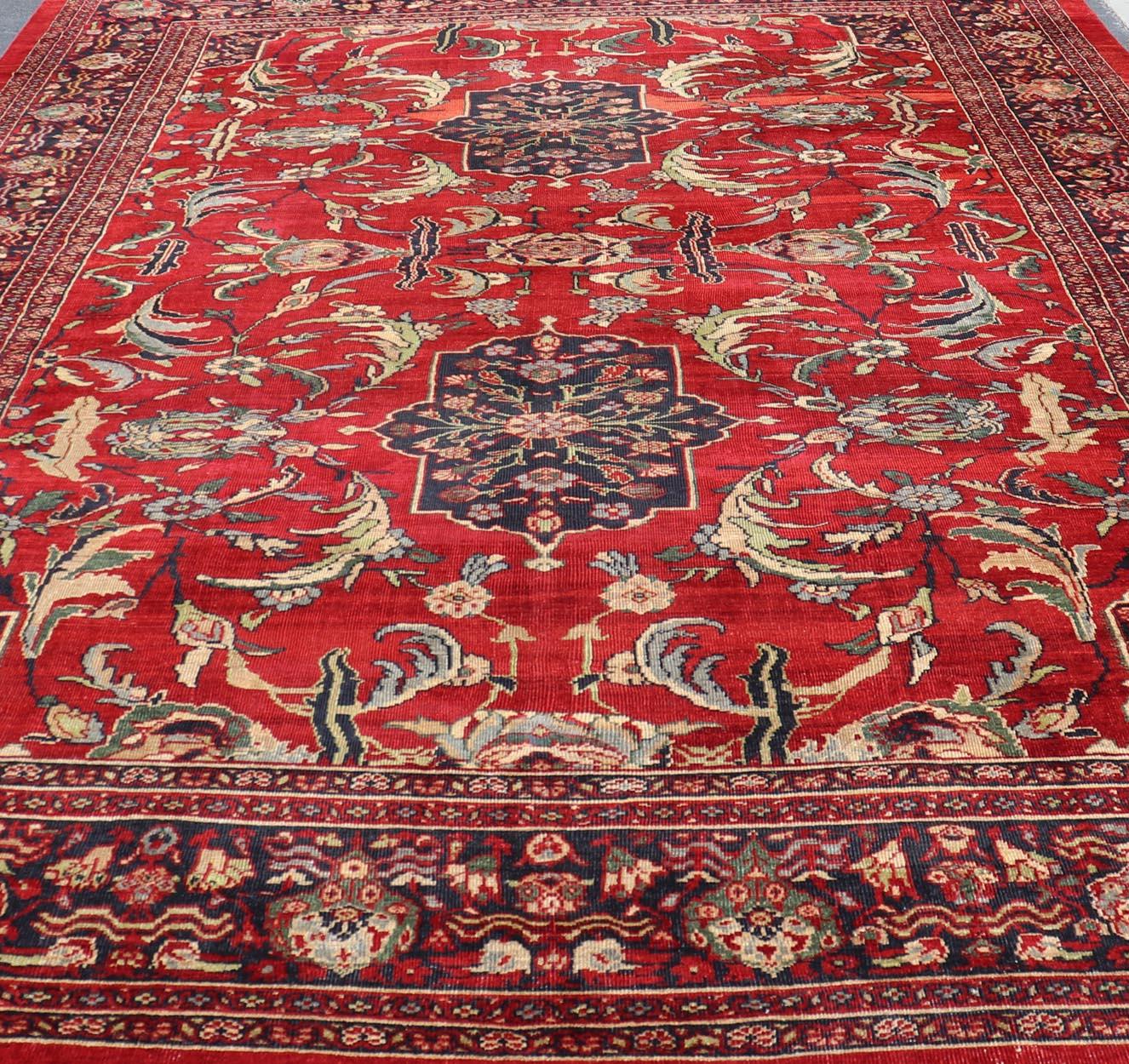 20th Century Antique Persian Zeigler Sultanabad Rug with Botanical Elements Set on Red Field For Sale