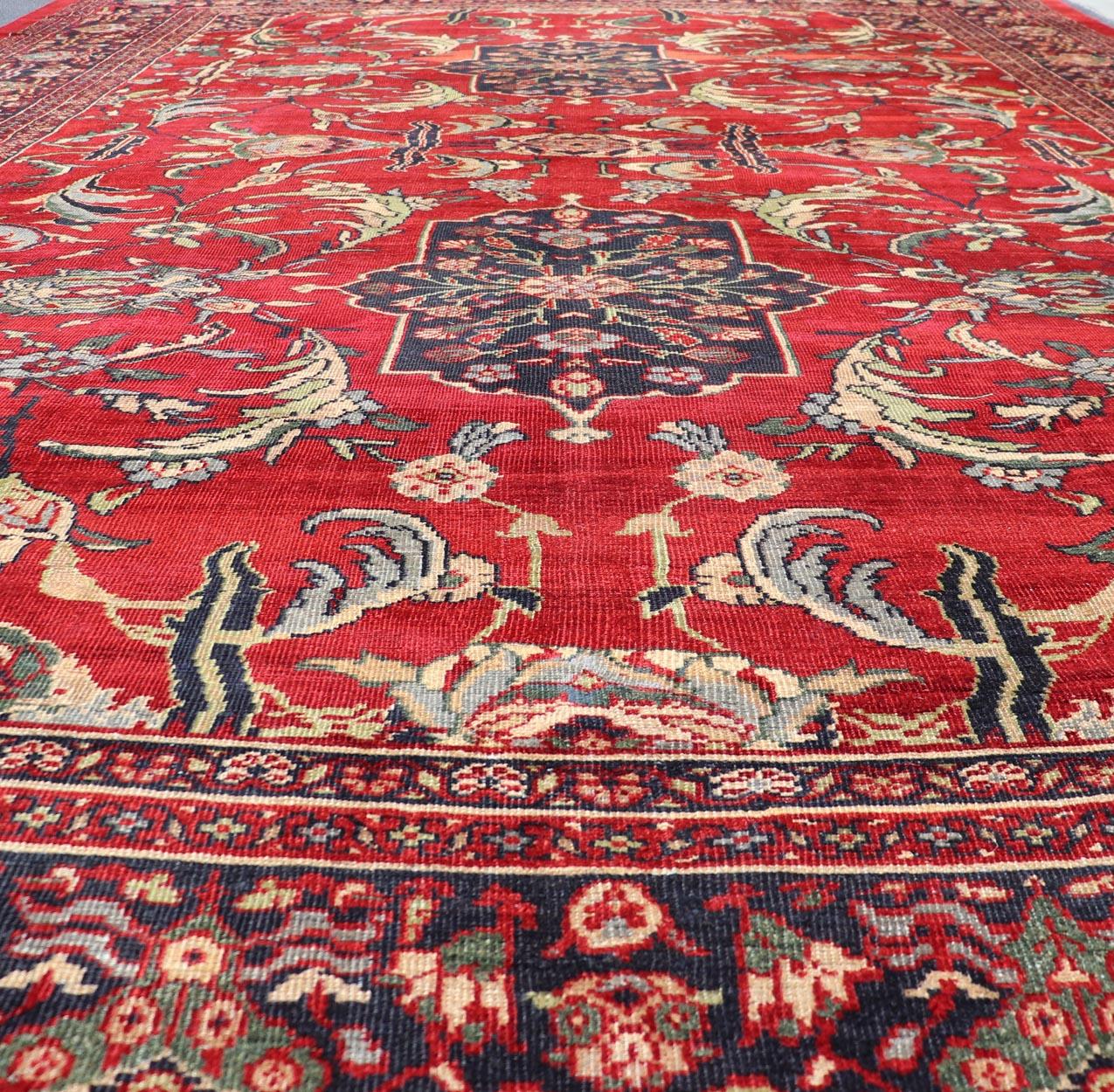 Wool Antique Persian Zeigler Sultanabad Rug with Botanical Elements Set on Red Field For Sale