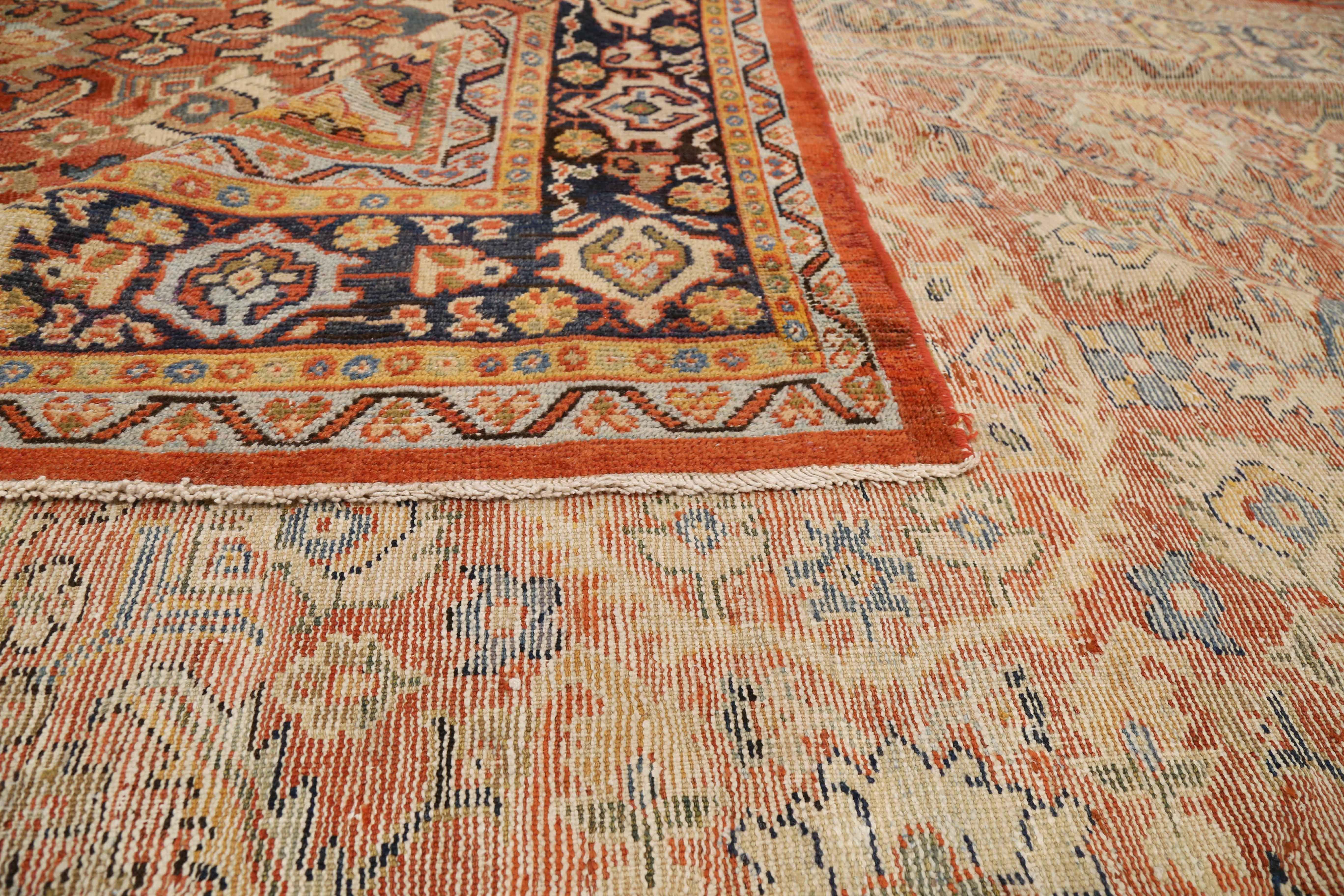 1920s-era antique Persian rug handwoven from exquisite sheep’s wool and tinted with all-organic dyes. It was made using a weaving style that made the work of Sultanabad weavers prominent in the world of Persian rugs. It features dynamic geometric