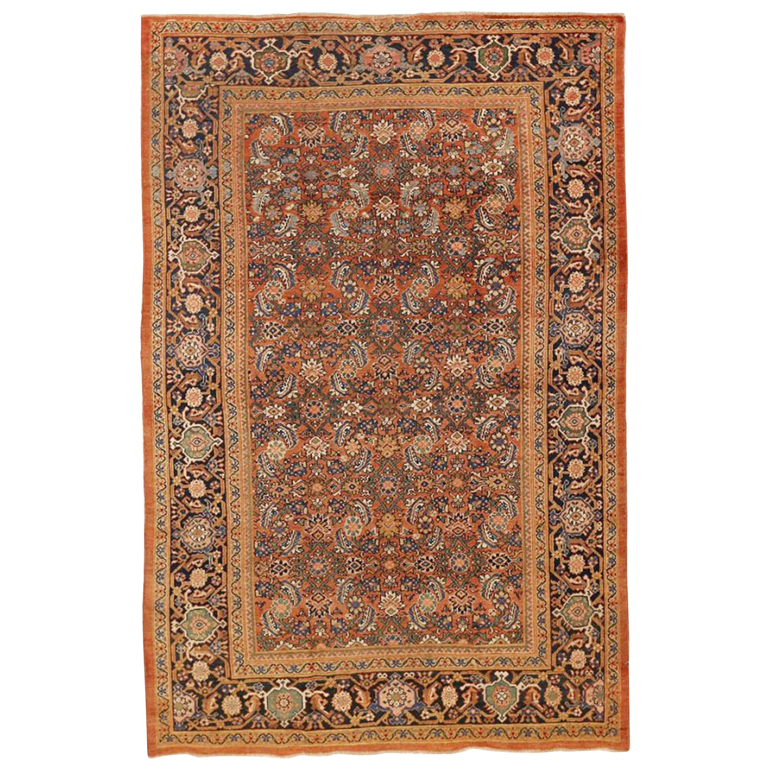 Antique Persian Sultanabad Rug with Navy and Green Floral Motifs on Orange Field For Sale