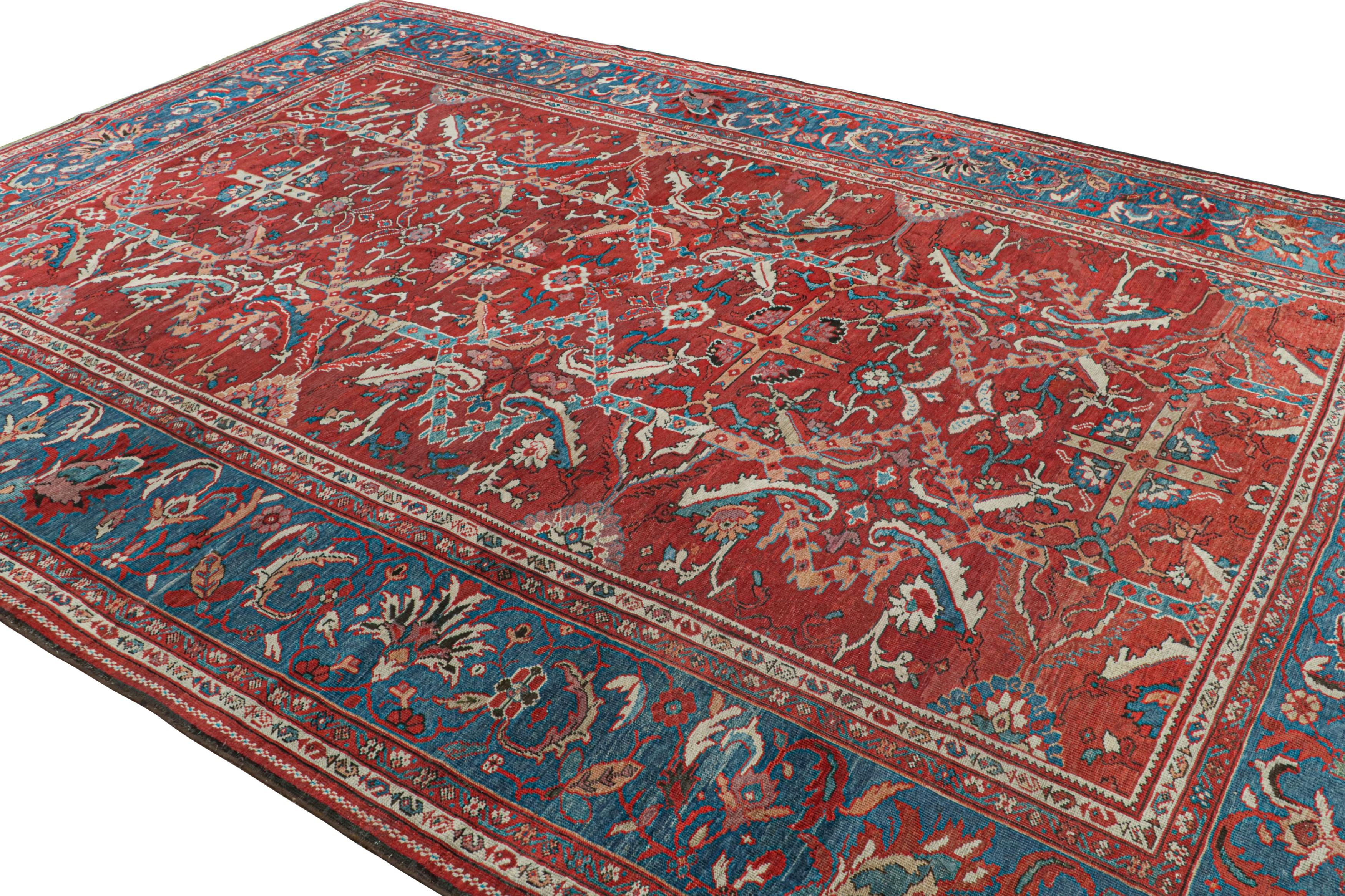 Hand-knotted in wool, an antique 9x13 Persian Sultanabad rug circa 1920-1930 - curated by Rug & Kilim.

On the Design:

This rug enjoys a red field with blue borders. Keen eyes will note the employment of the same colors as the floral patterns with