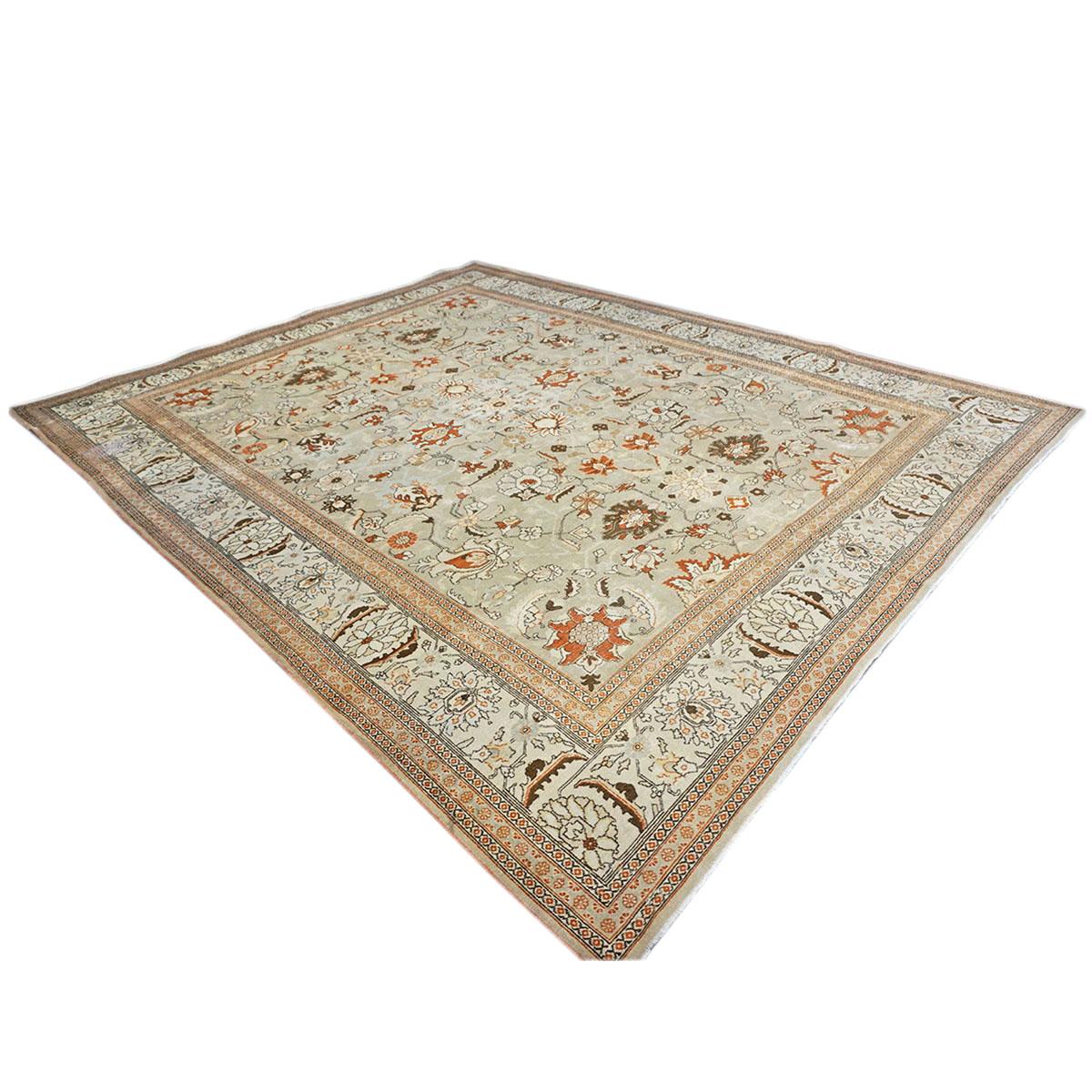 Ashly fine rugs presents a 1910s Antique Persian Tabriz. Tabriz is a northern city in modern-day Iran and has forever been famous for the fineness and craftsmanship of its handmade rugs. This piece has a light tan-colored background, with the