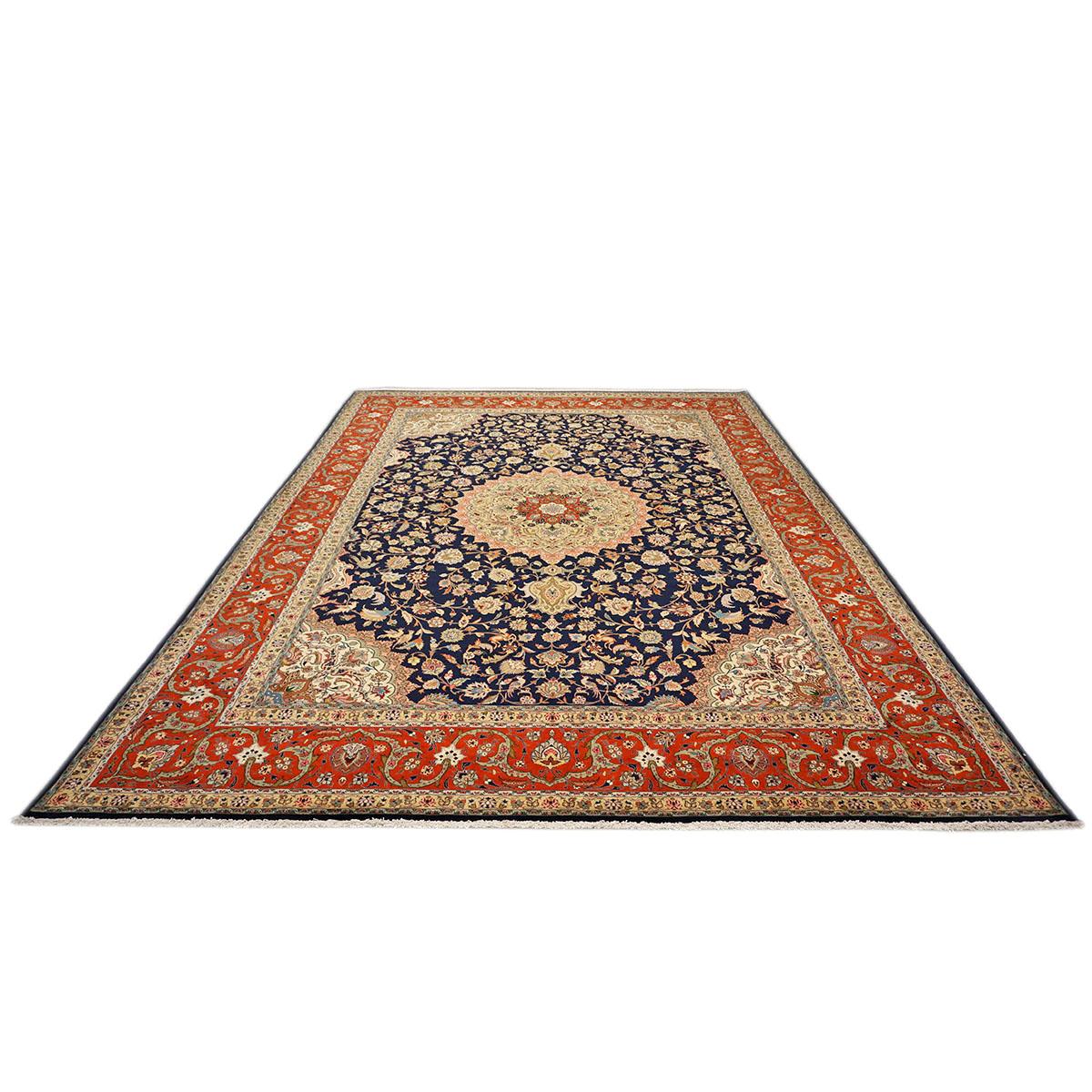 Ashly Fine Rugs presents a 1940s Antique Persian Tabriz. Tabriz is a northern city in modern-day Iran and has forever been famous for the fineness and craftsmanship of its handmade rugs. This piece has a beautiful deep navy blue background with the