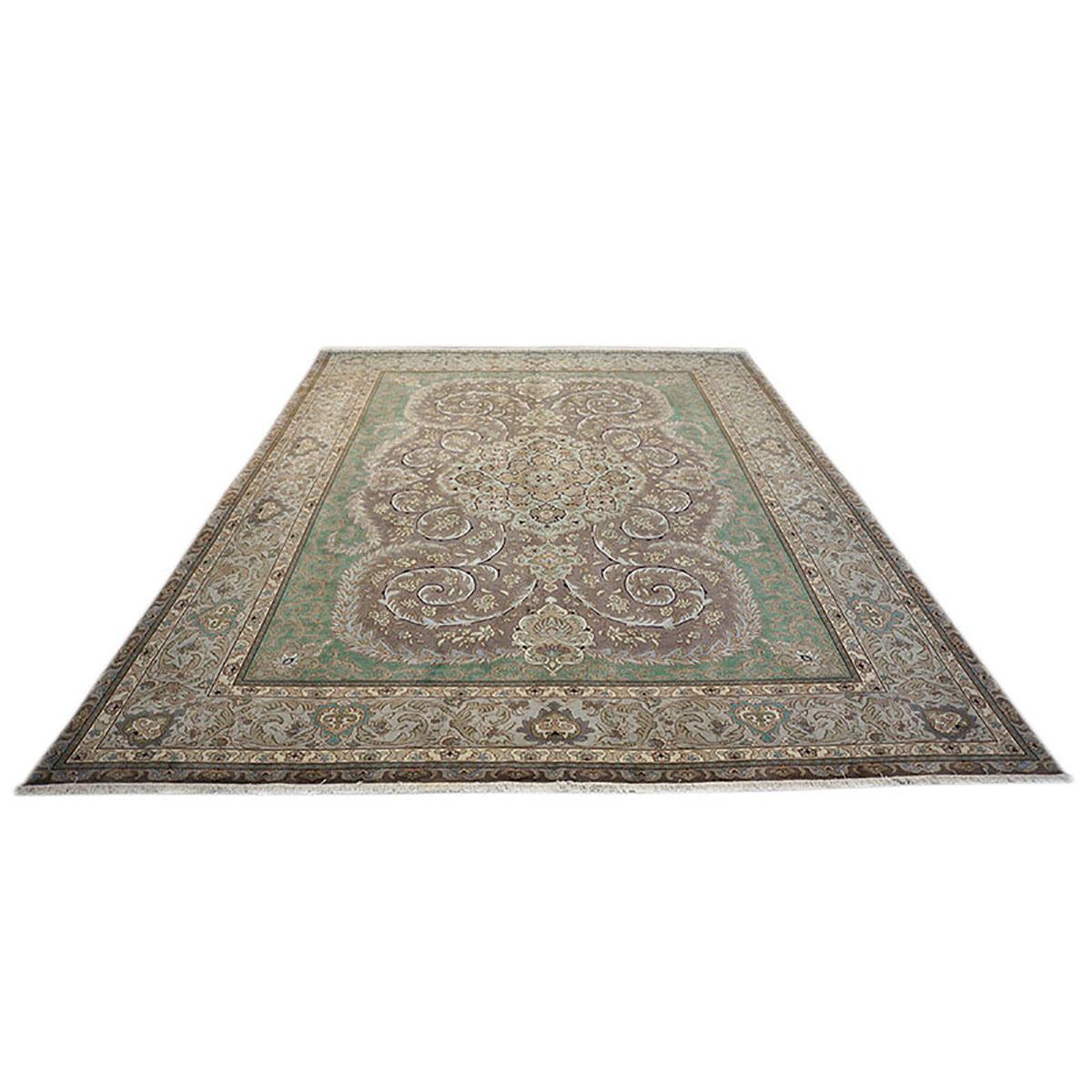 Ashly Fine rugs presents a 1930s Antique Persian Tabriz. Tabriz is a northern city in modern-day Iran and has forever been famous for the fineness and craftsmanship of its handmade rugs. This piece has a fern green-colored background with design,