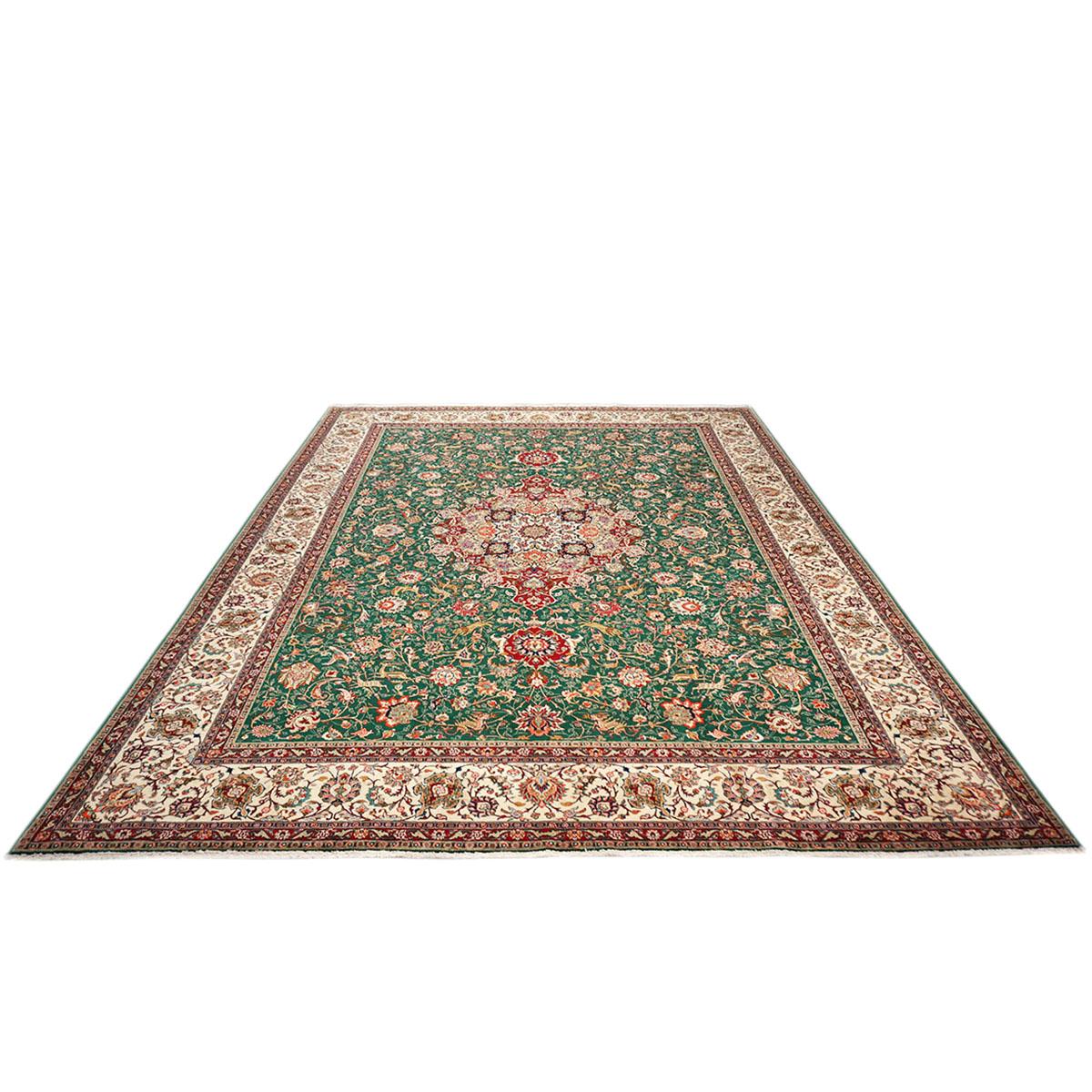 Ashly fine rugs presents a 1940s Antique Persian Tabriz. Tabriz is a northern city in modern-day Iran and has forever been famous for the fineness and craftsmanship of its handmade rugs. This piece has a green-colored background, with the design,