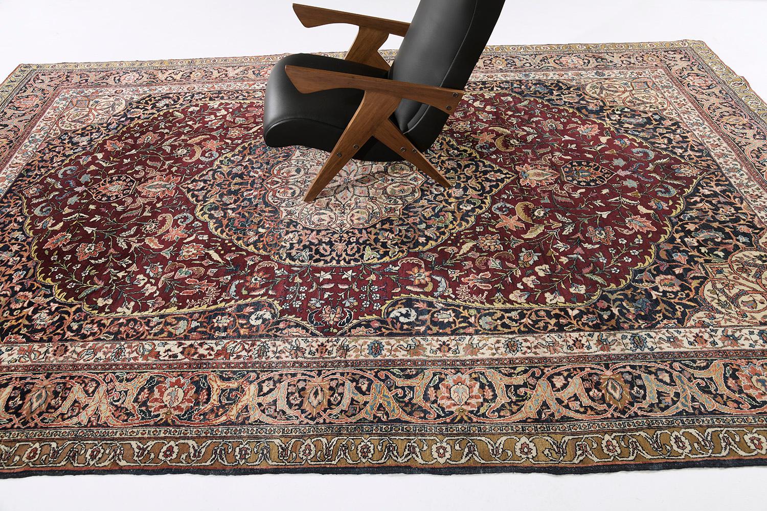 A grandiose Antique Persian Tabriz rug with infinite forms that complement with each other in a brilliant dance of contrast and synchronization. Featuring the impressive colour scheme that will captivate your attention, this timeless rug comprises