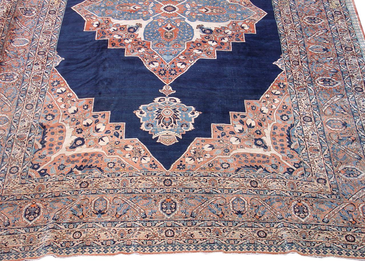 Antique Large Persian Tabriz Carpet, 19th Century

Tabriz carpets are known for their fine weave, remarkable detailing, and intricate drawing. The classic central medallion of this oversized piece floats against a deep indigo ground. It is framed by