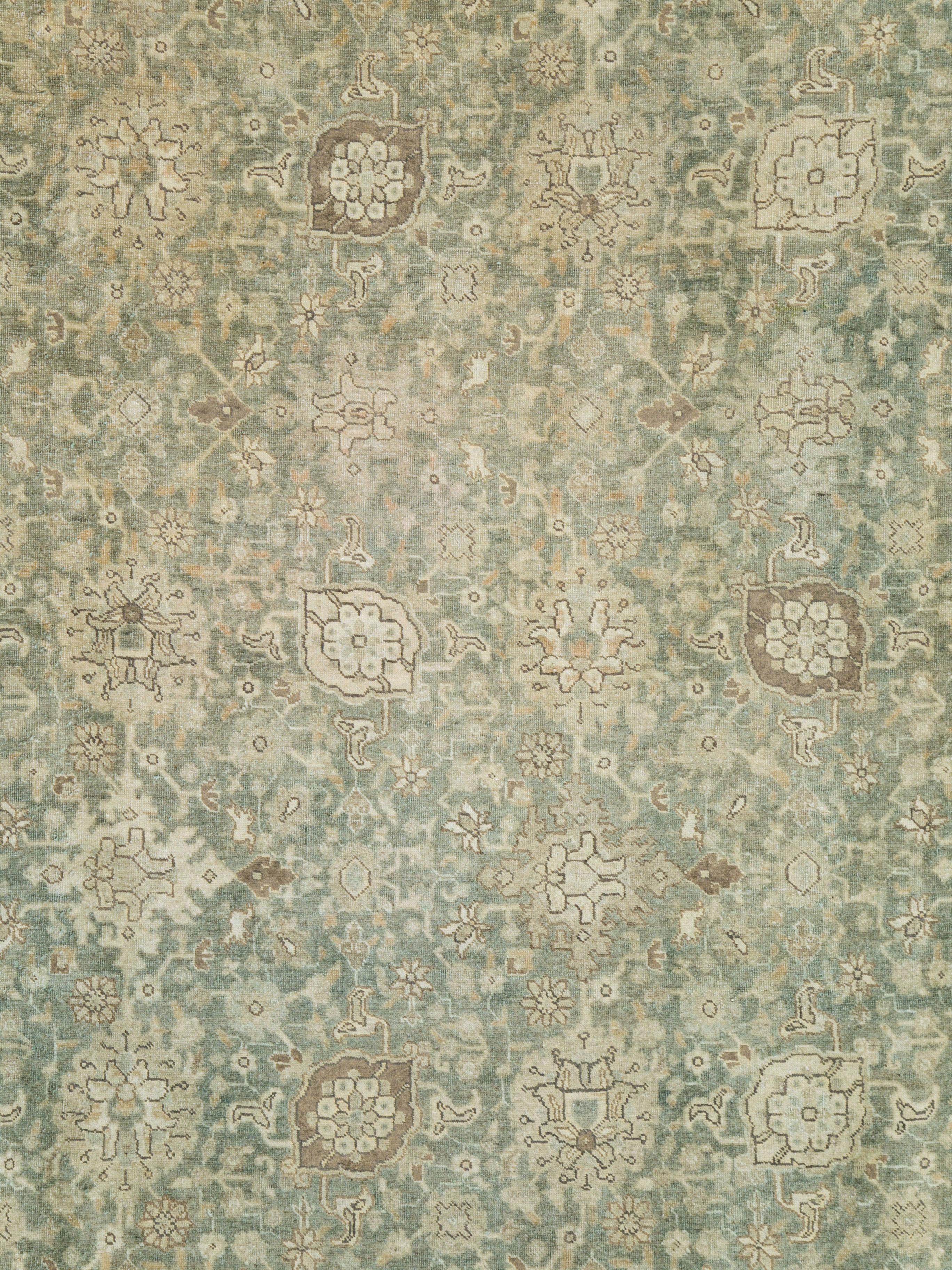 An antique Persian Tabriz carpet from the early 20th century.