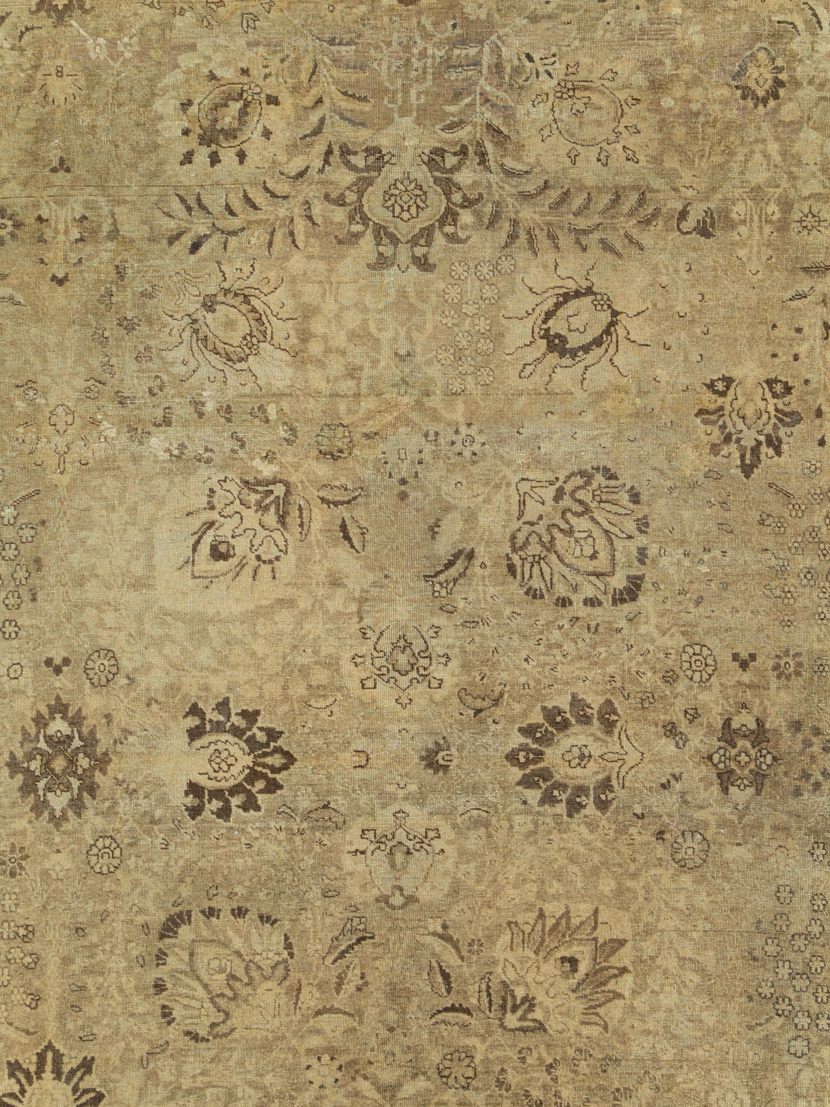 An antique Persian Tabriz carpet in shades of gold from the first quarter of the 20th century.