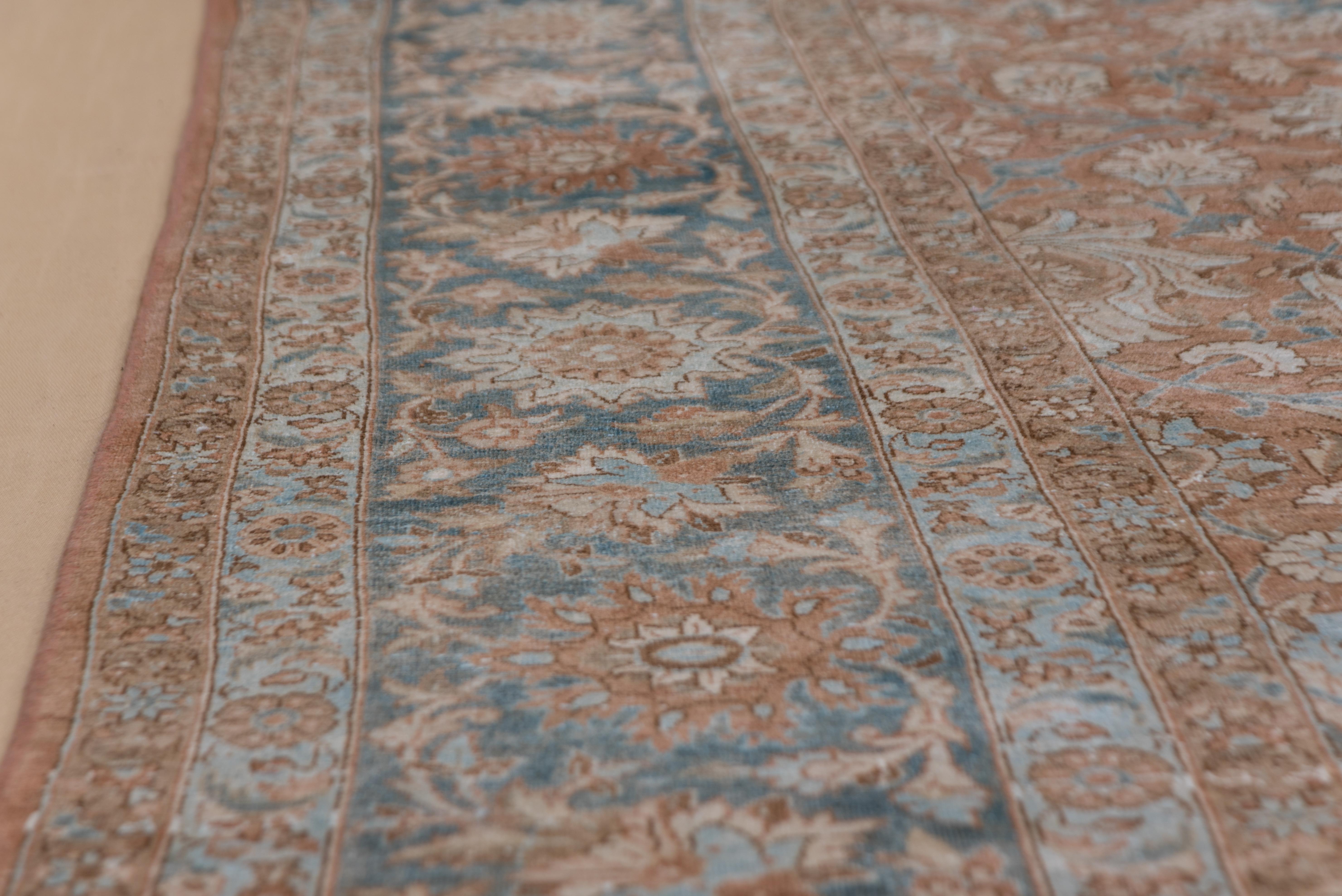 This NW Persian city carpet shows a Classic all-over pattern of a variety of petal palmettes, blue vinery, and pale blue and teal details on a muted terracotta field. Teal blue palmette and rinceau border. Good condition, well woven.
  