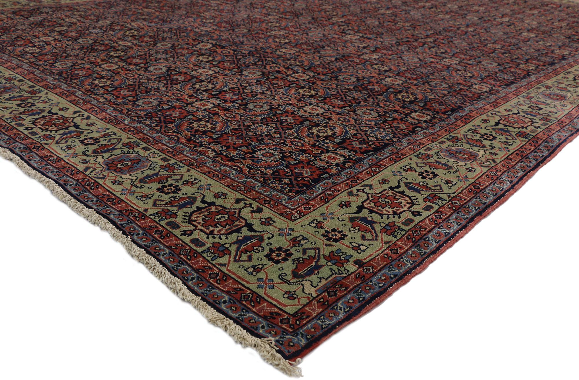 73346 Antique Persian Tabriz Rug with Classic Herati Design. This opulent hand-knotted wool antique Persian Tabriz rug features an all-over Herati pattern spread across an abrashed dark navy blue field. The classic Herati pattern, also known as the