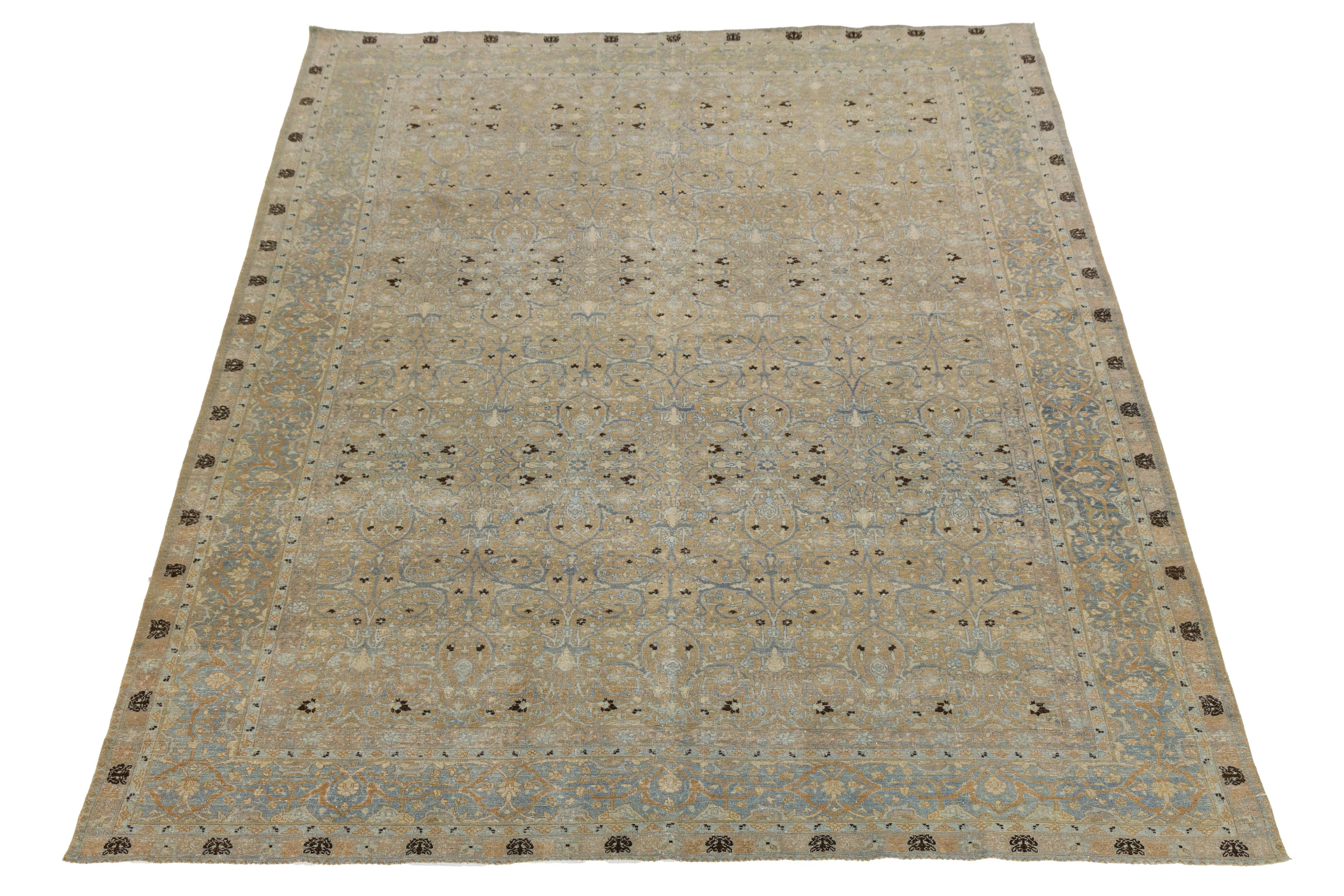 This hand-knotted antique Tabriz rug is distinguished by its intricate designs, incorporating a palette of muted beige, soft blue, and warm brown tones.

This rug measures 9' x 12'6