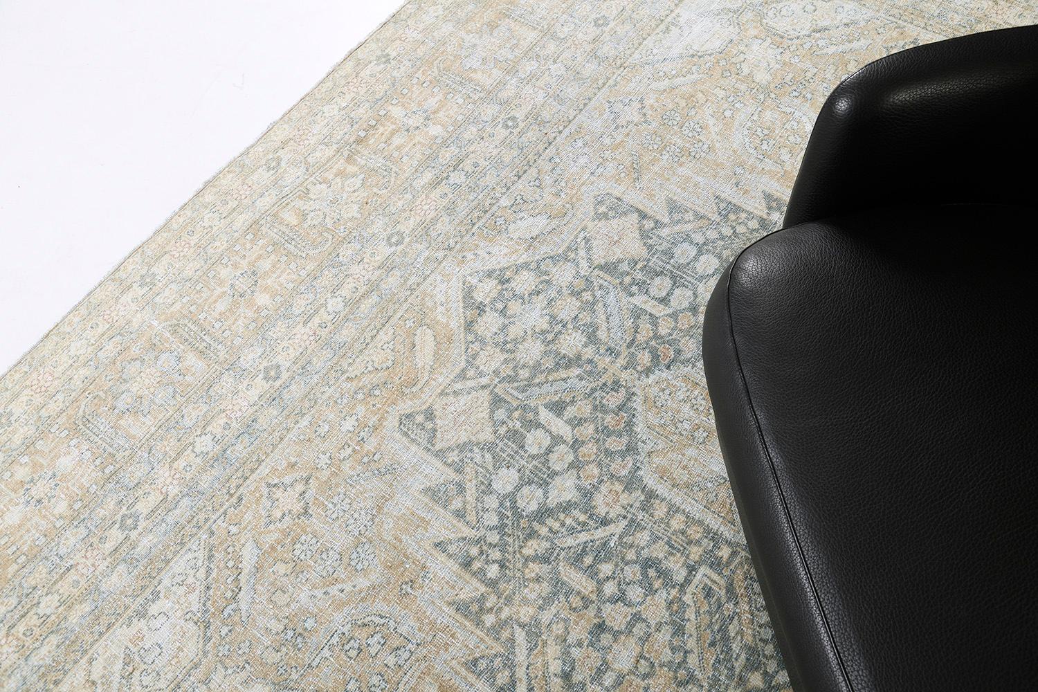 Featuring a central lozenge medallion that is composed of palmettes and stylized florals, this Antique Persian Tabriz is a piece that you will not resist. The abrashed golden field is graciously covered with an all-over botanical pattern that adds