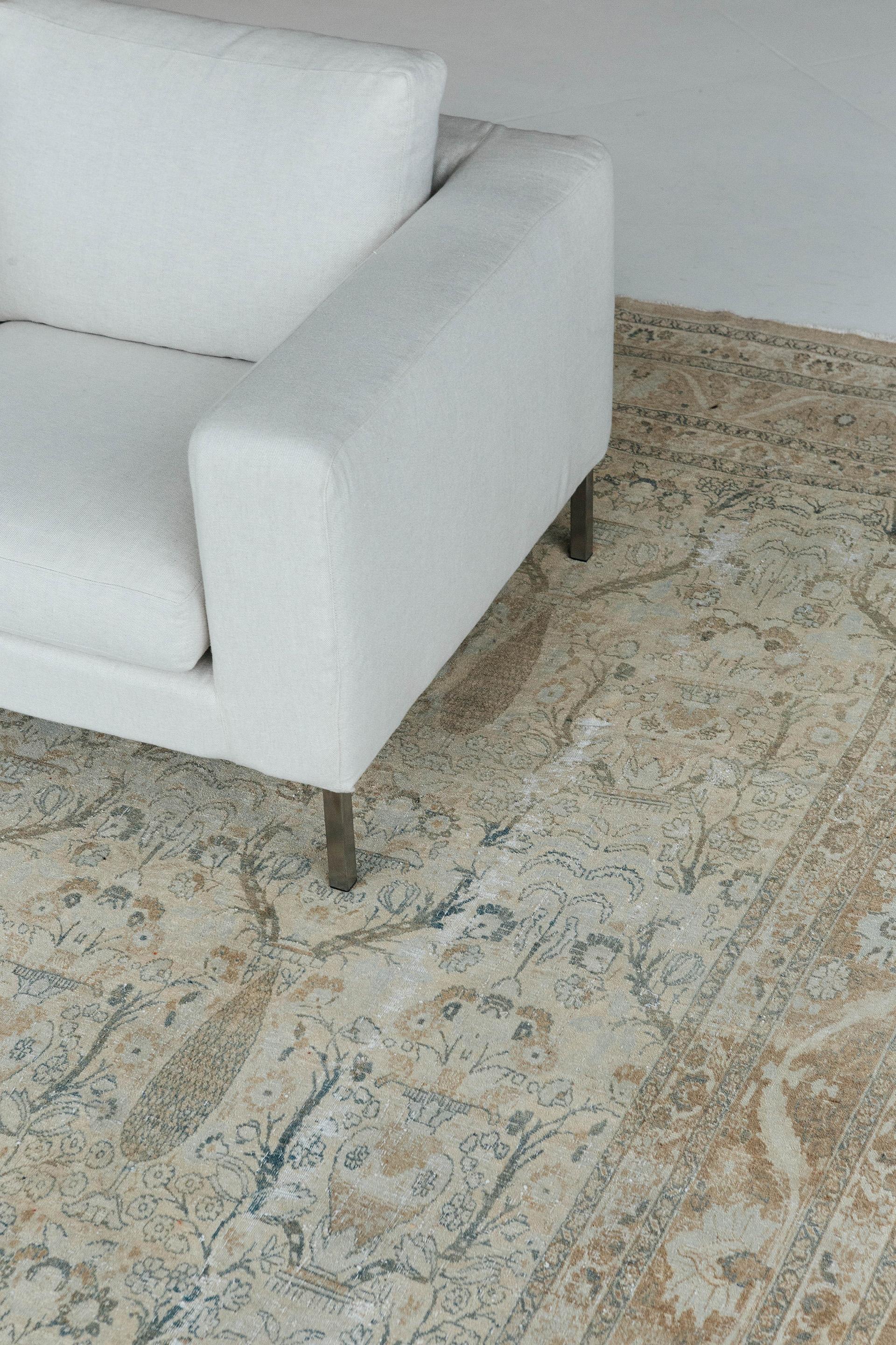 Antique Tabriz in soft warm tans and teal gray accents in the style of Hadji Jalil, a legendary designer of courtly rugs. All-over field pattern, organized in rows, features vase elements and cyprus trees. Border features undulating vine and
