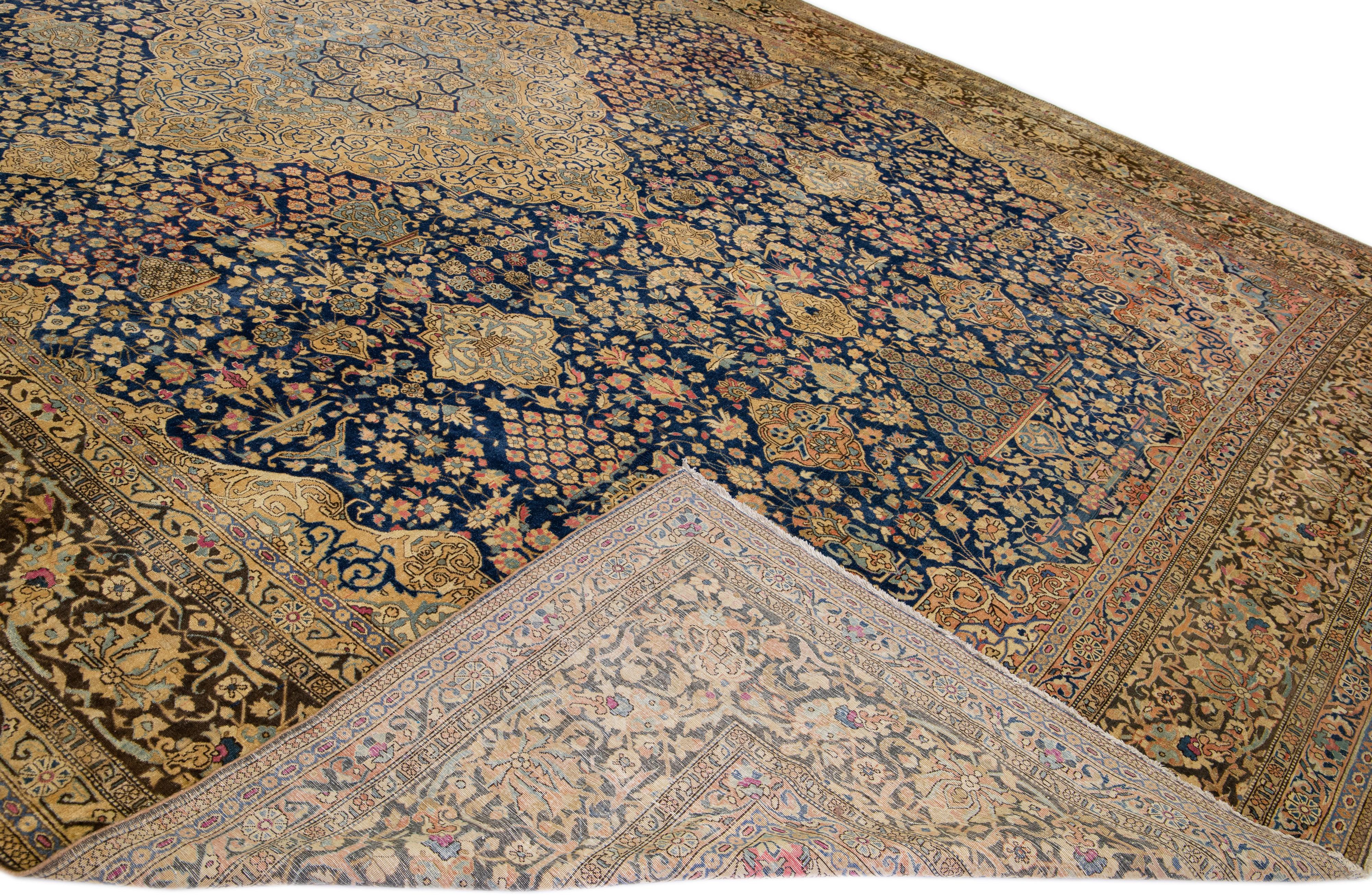 Beautiful antique Persian Tabriz hand-knotted wool rug with a navy blue field. This piece has multicolor accents in an all-over gorgeous floral design.

This rug measures: 14' x 22'. 
 