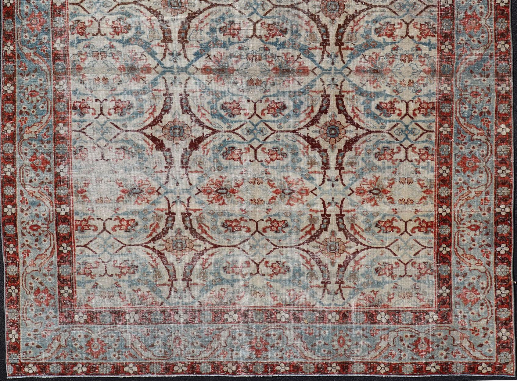 Antique Persian distressed Tabriz rug with all-over floral design in ivory, red, brown, light blue, rug EMB-8507 , country of origin / type: Iran / Tabriz, circa 1920

This distressed antique Persian Tabriz carpet features a refined palate of
