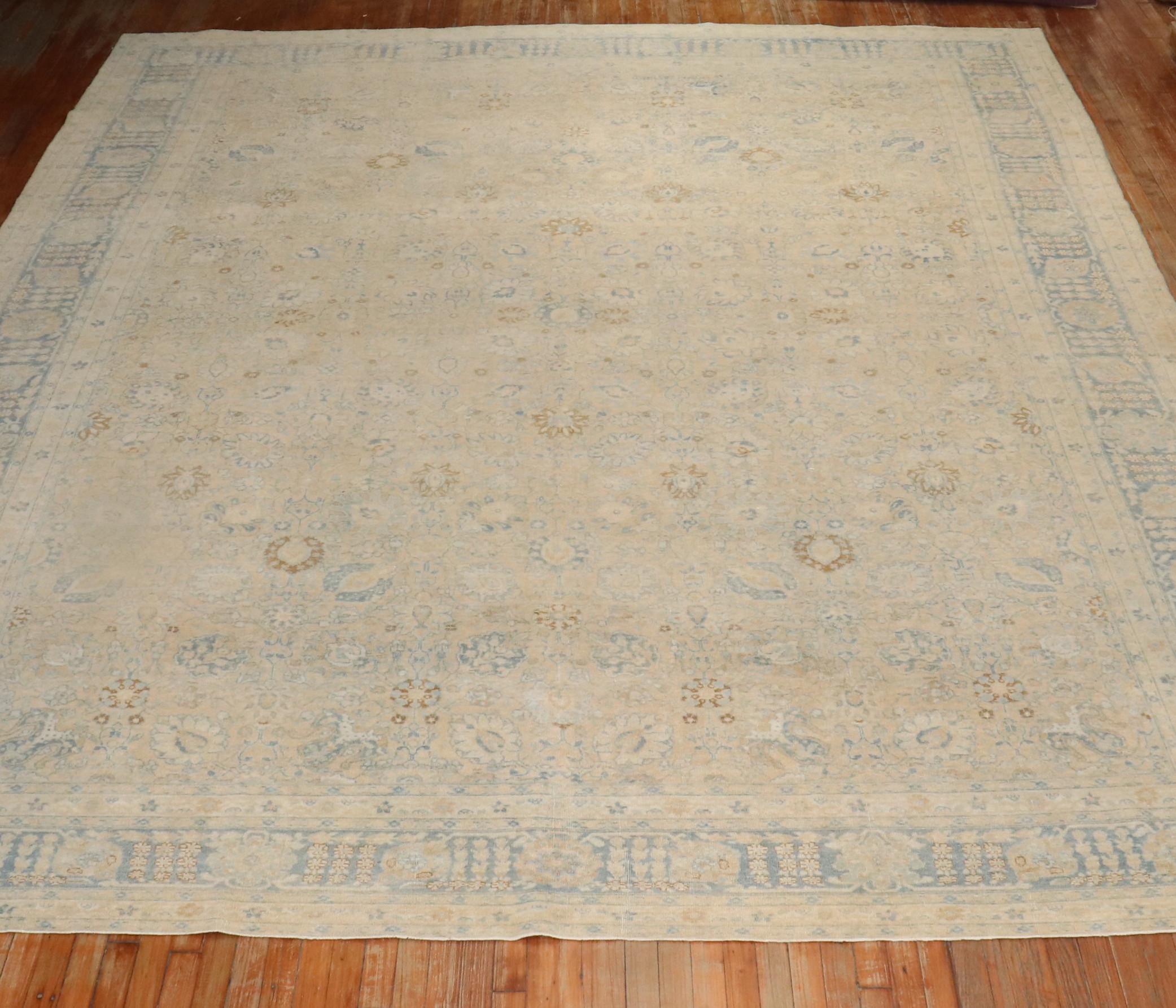 1920s large room size Persian Tabriz rug with an all-over design with light blue and cream accents on a butter color ground

Measures: 11'4'' x 14'.