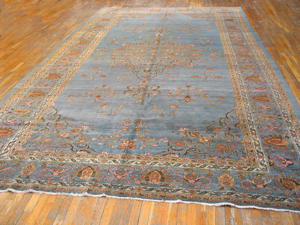 Light blue is always popular and on this late 19th century urban Tabriz carpet the field show through the openwork medallion, corners and even the main border of palmettes and cypresses. The plain blue outer band continues the basic tonality in a