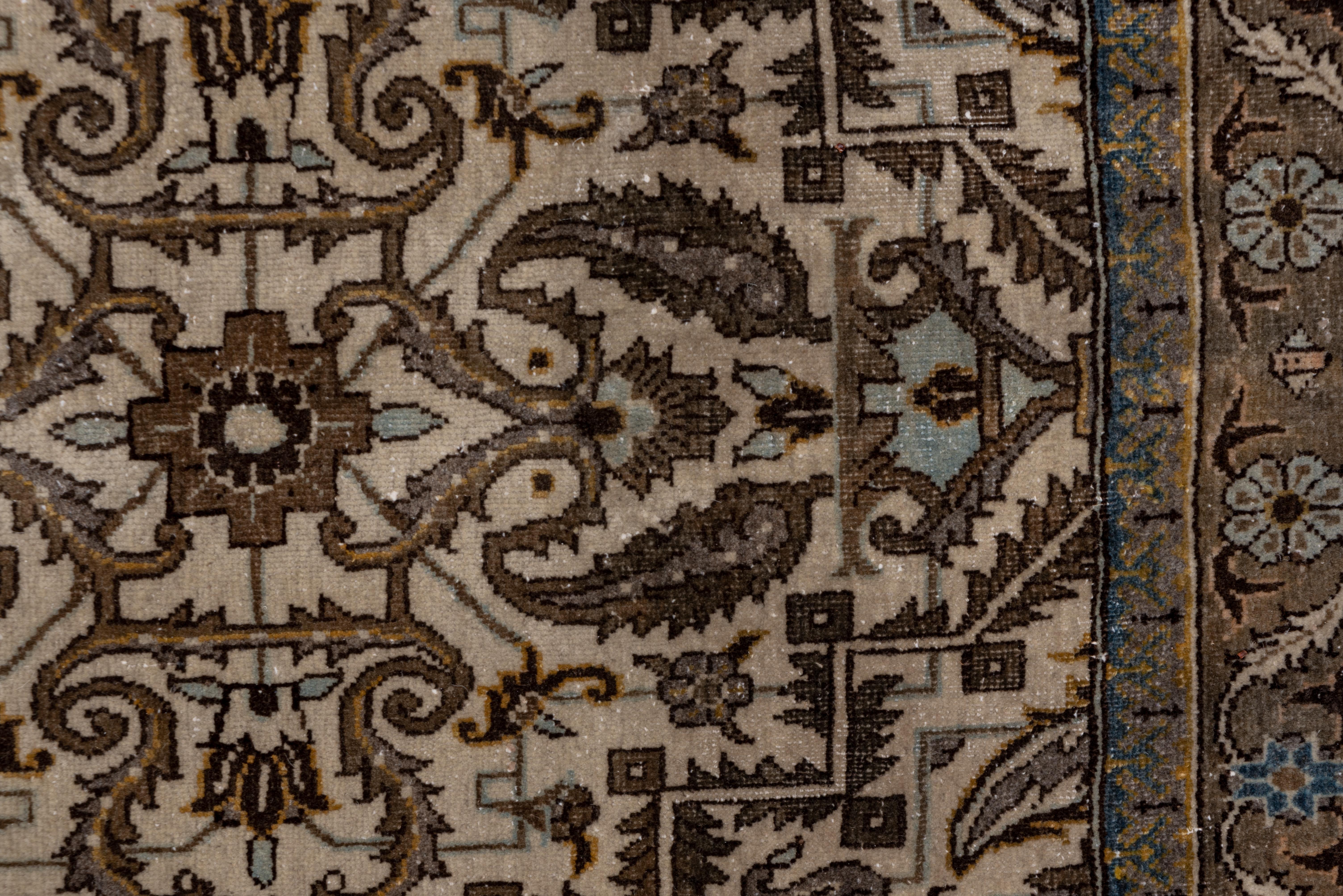 This urban, well-woven NW Persian carpet presents an ecru field with horizontal lines of various, paired leaves, some creating reserves centering rosettes, with vertical lines of leaves forming squares enclosing more rosettes. Some leaves have boteh