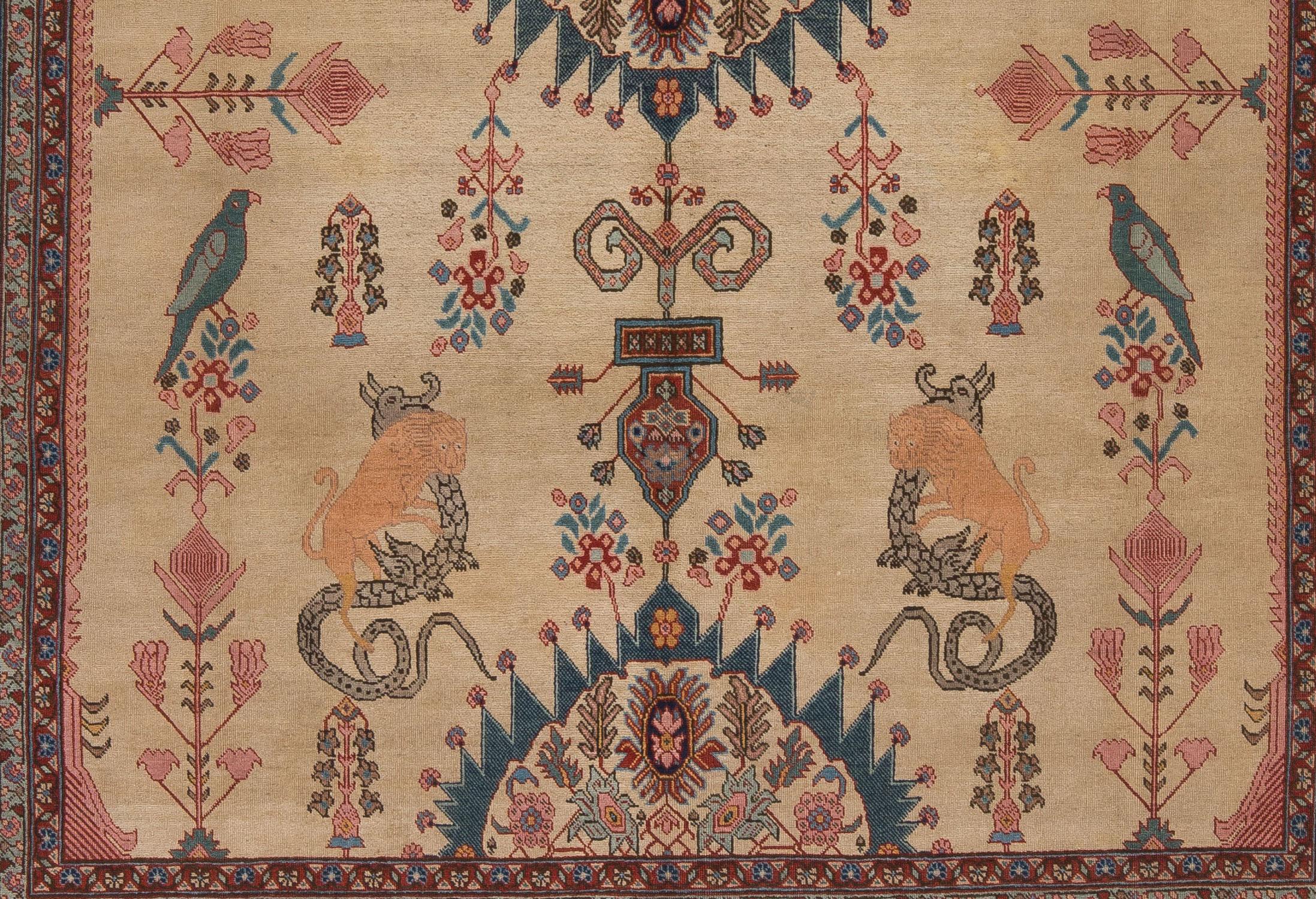 An unusual, turn of the century Antique Persian Tabriz with a warm ivory field and whimsical design incorporating animals and floral motifs. A finely woven, sophisticated carpet with an even, low wool pile. Naturally dyed with navy, indigo, pink,
