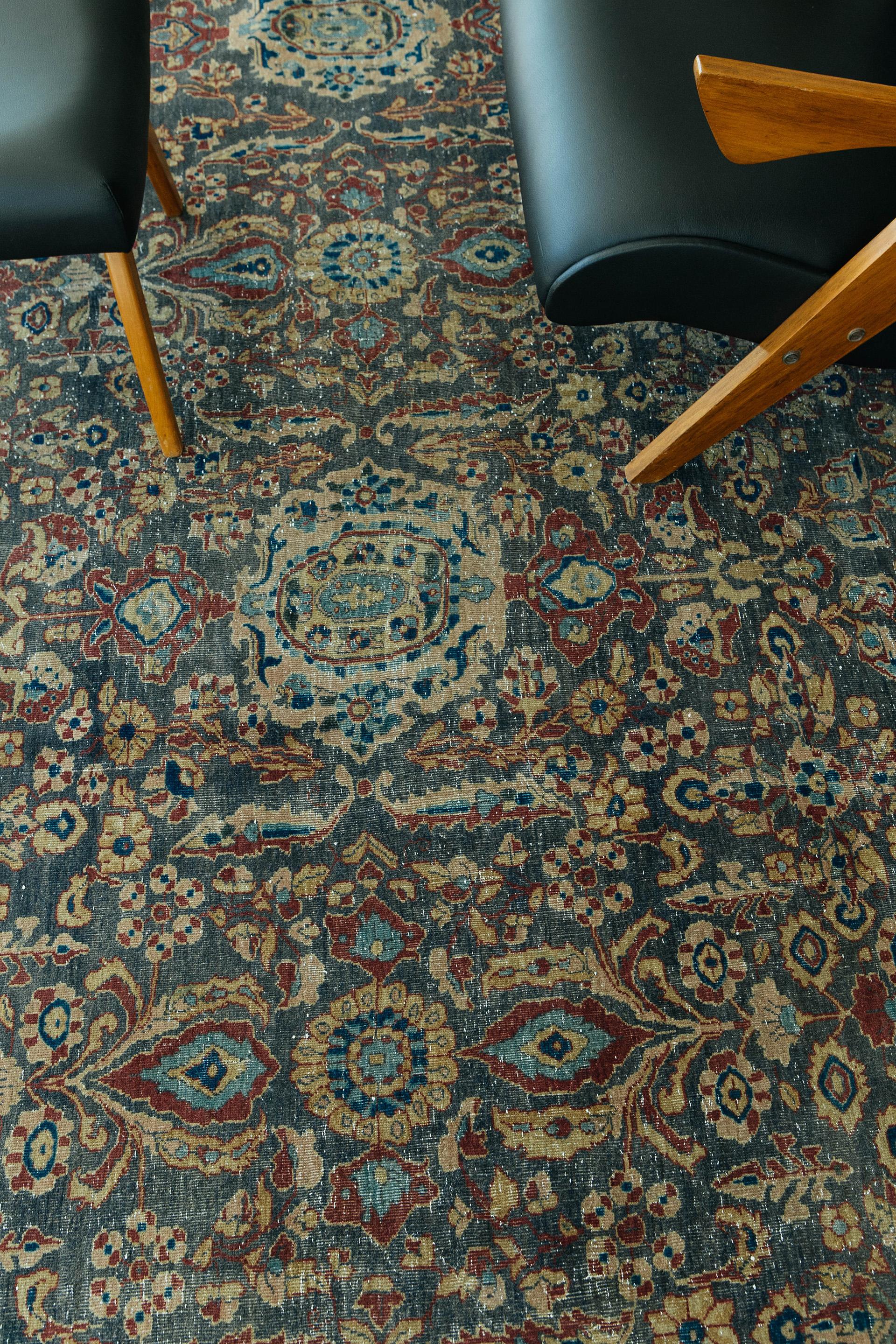 Antique Tabriz with a rich deep palette of teal and warm tan with clear blue and burgundy accents. The all-over field clambers with palmettes, medallions, rosettes, serrated leaves and is completed in matching borders of softer color contrasts. The