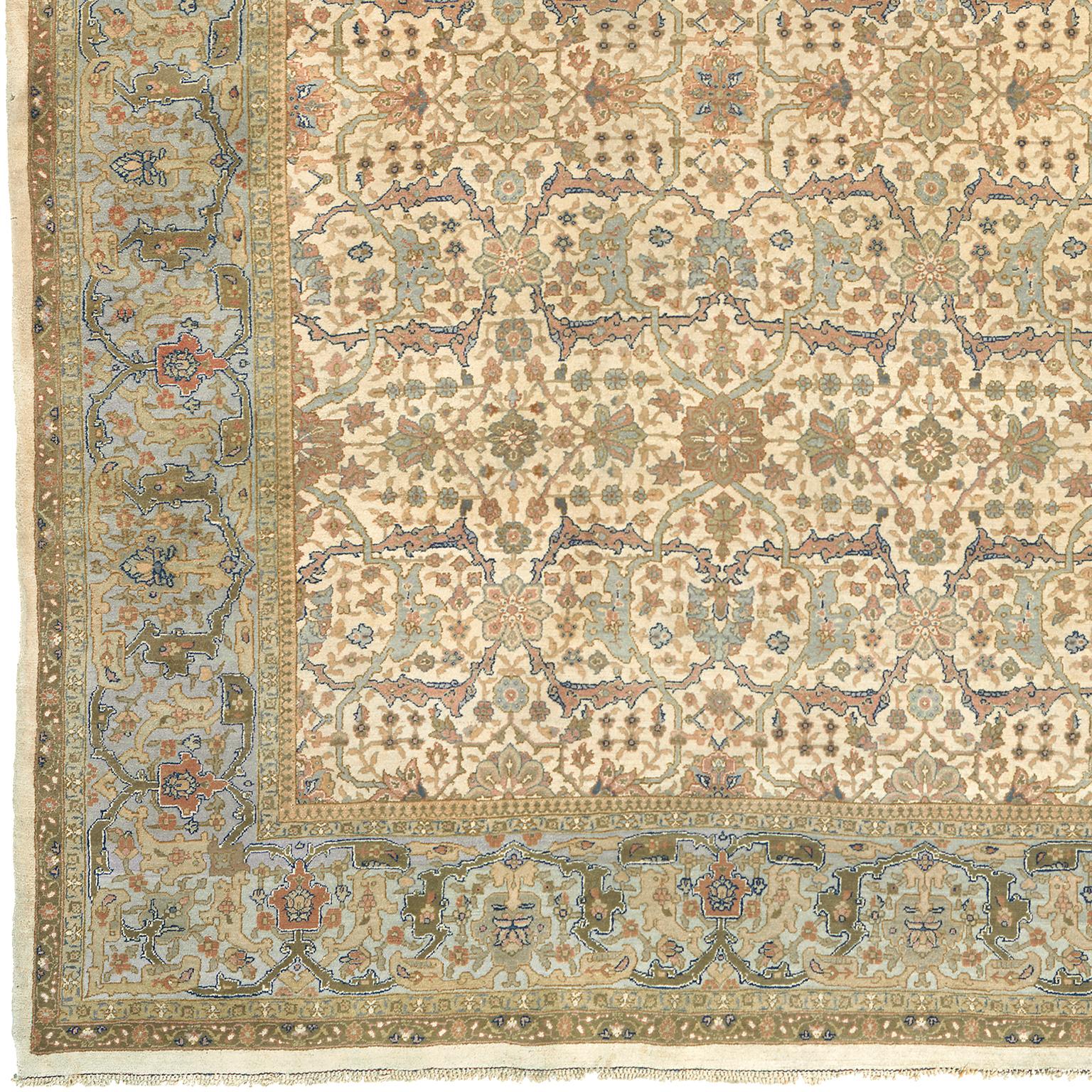 Antique Persian Tabriz rug.
North-West Persia, circa 1900.
The ivory field with an overall design of rosettes linking interlocking lattices of dusty pink and pale grey arabesques forming panels containing flowering vine, in a pale grey border of