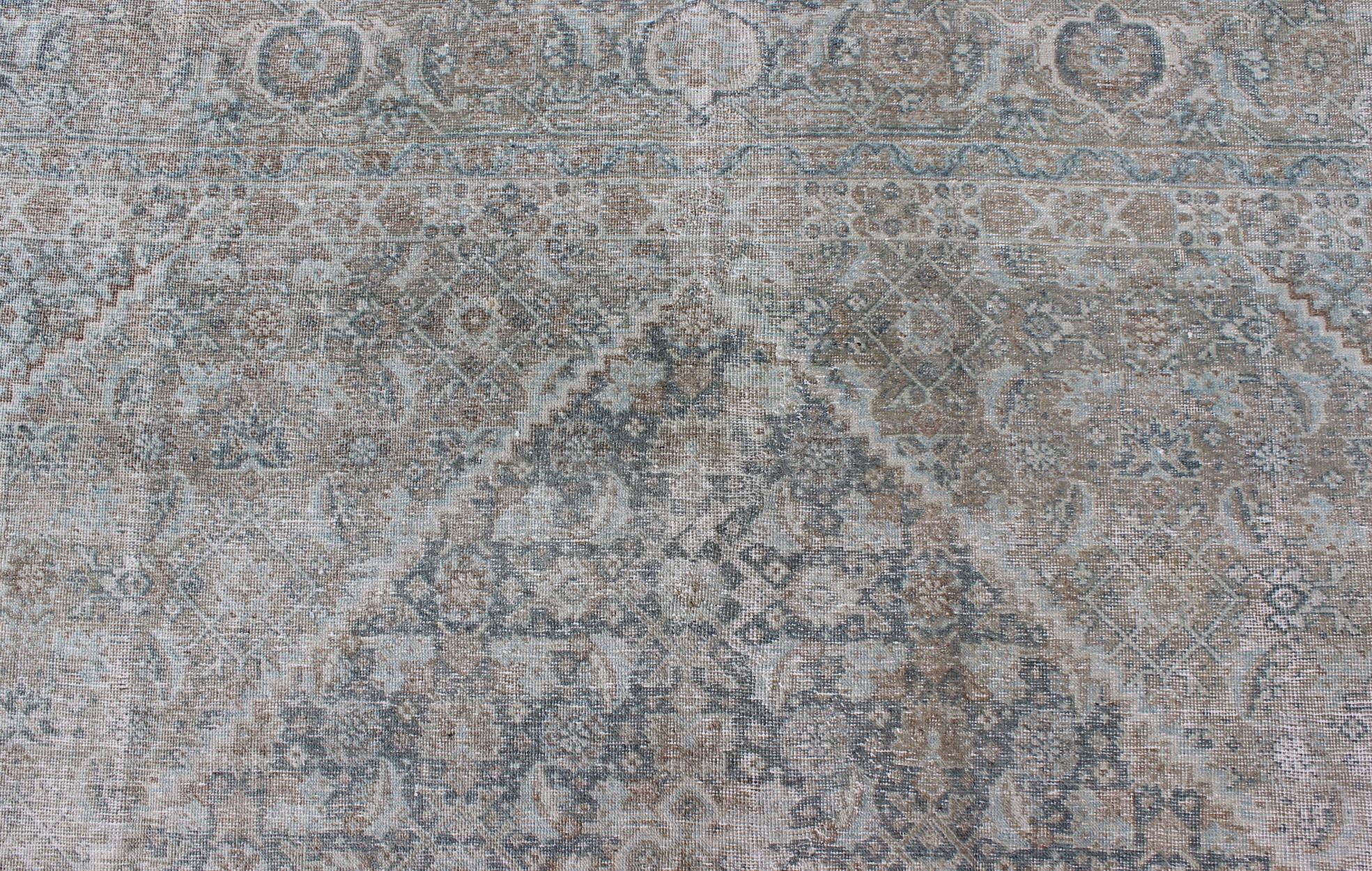Early 20th Century Antique Persian Tabriz Rug in Muted Colors with Layered Medallion Design