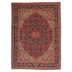 Antigua alfombra persa de Tabriz con motivos florales rojos, negros y marfil por todas partes