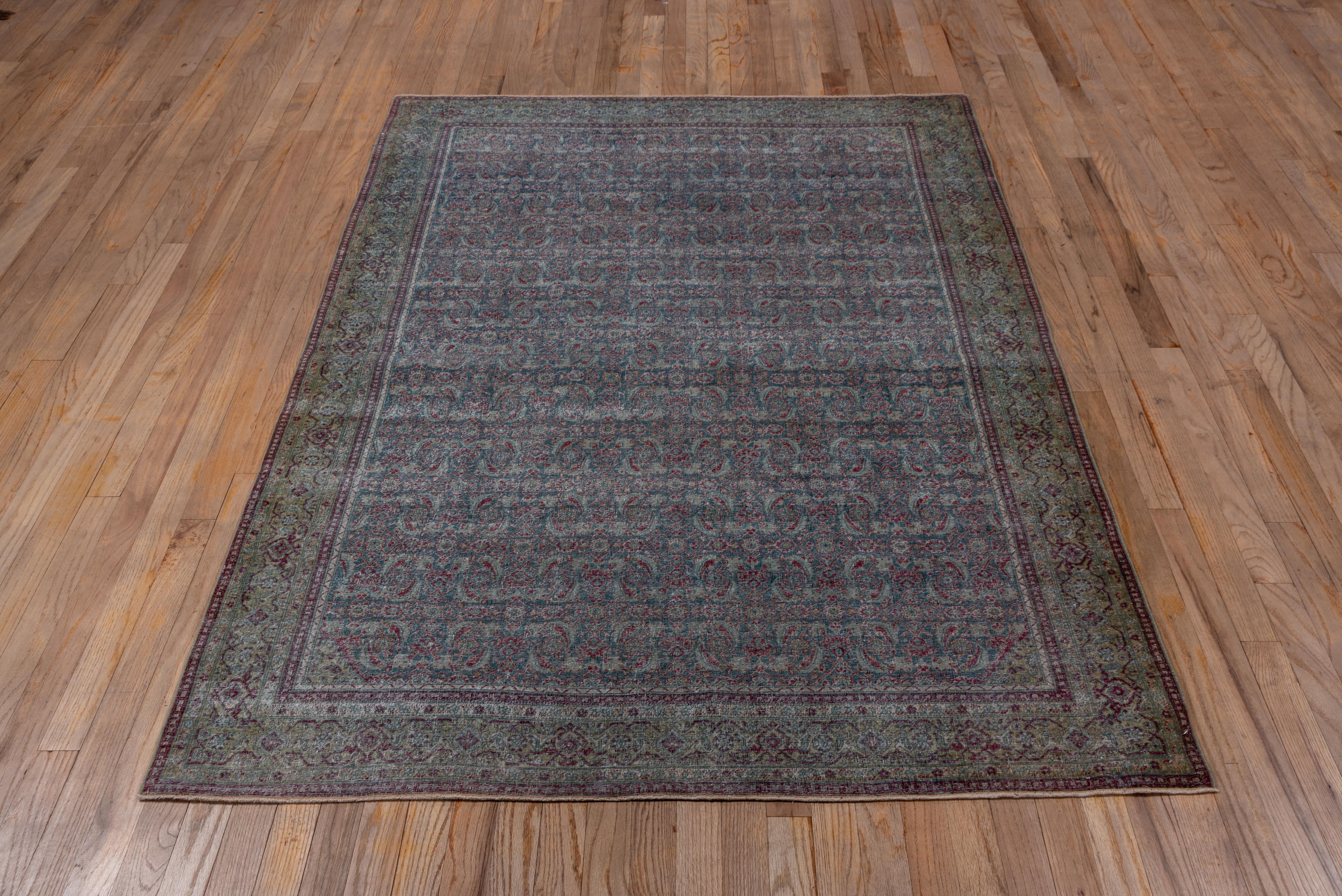 This finely knotted NW Persian city scatter has a minutely rendered Herati design on a slate ground, unfortunately worn to distressed. The camel reversing turtle palmette border shows charcoal accents.