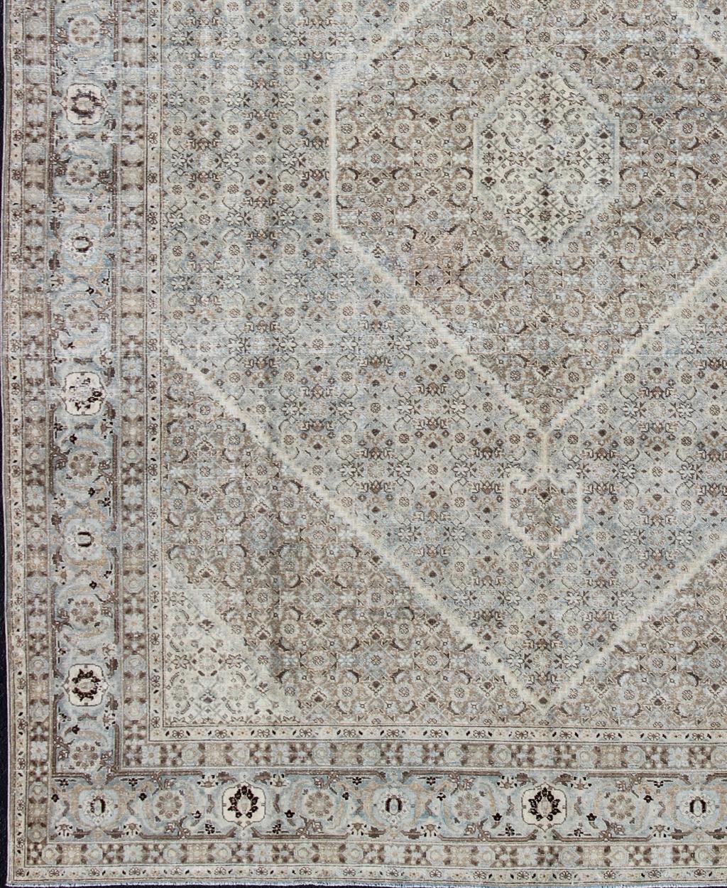 Gray, light blue, taupe, tan and brown geometric Persian Tabriz rug, rug SUS-1908-352, country of origin / type: Iran / Tabriz, circa 1920

This antique Tabriz carpet from 1920s Persia features a field filled with small-scale geometric motifs