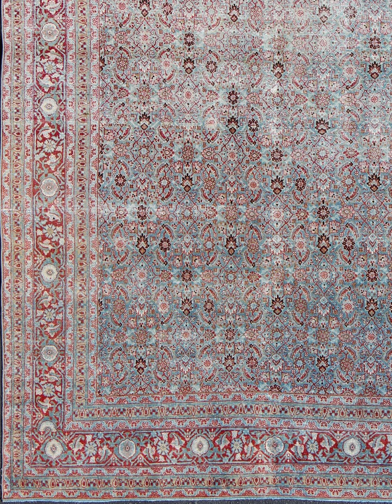 Light blue and red Persian Tabriz rug antique sub floral and geometric design, Keivan Woven Arts / rug ema-7538, country of origin / type: Iran / Tabriz, circa 1910.

This antique Persian Tabriz carpet (circa 1910) features a refined palate of light