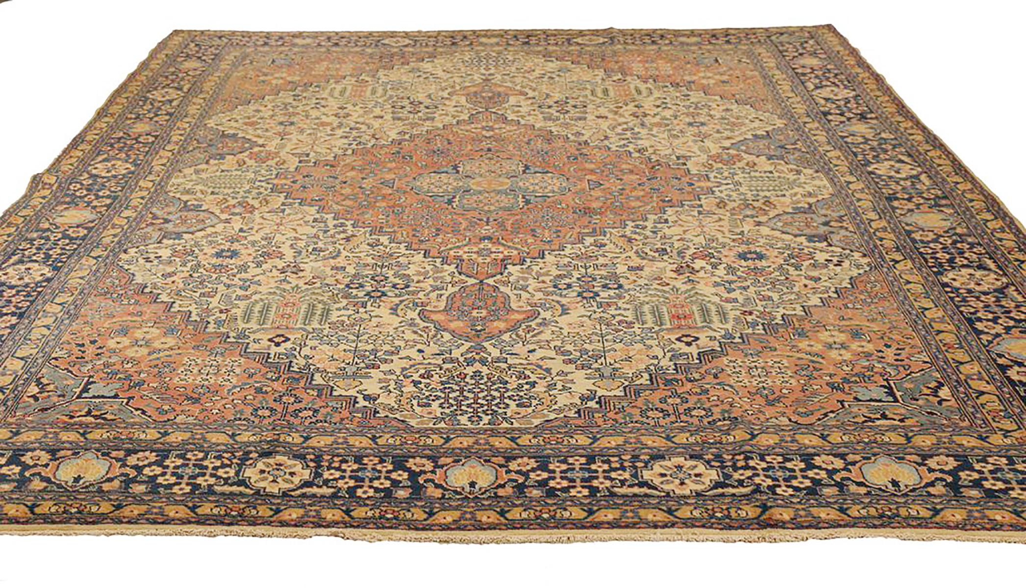 Antique Persian rug handwoven from the finest sheep’s wool and colored with all-natural vegetable dyes that are safe for humans and pets. It’s a traditional Tabriz weaving featuring a lovely ensemble of floral designs in beige and navy. It’s a