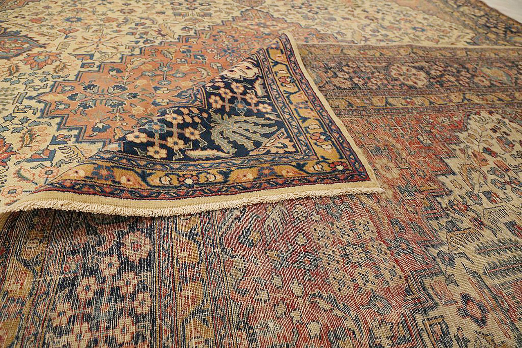 Hand-Woven Antique Persian Tabriz Rug with Beige and Navy Flower Details Over Ivory Field For Sale