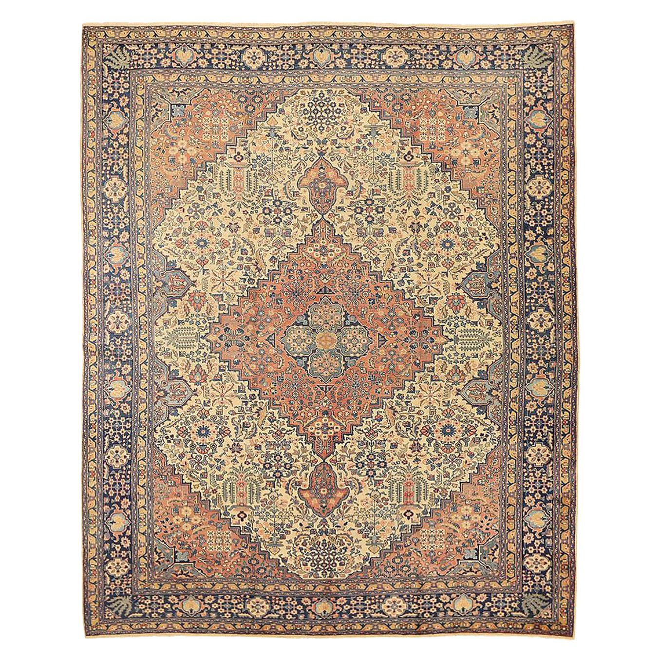 Antique Persian Tabriz Rug with Beige and Navy Flower Details Over Ivory Field For Sale