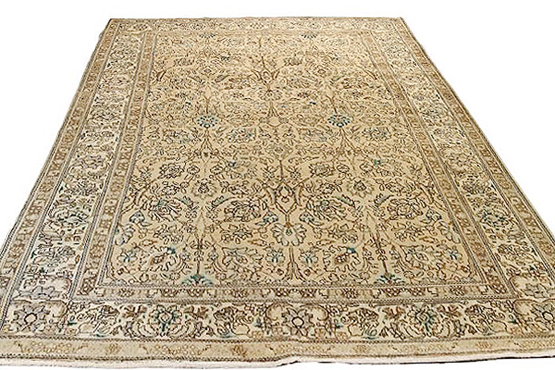 Antique Persian rug handwoven from the finest sheep’s wool and colored with all-natural vegetable dyes that are safe for humans and pets. It’s a traditional Tabriz weaving featuring a lovely ensemble of floral designs in black and green over a beige