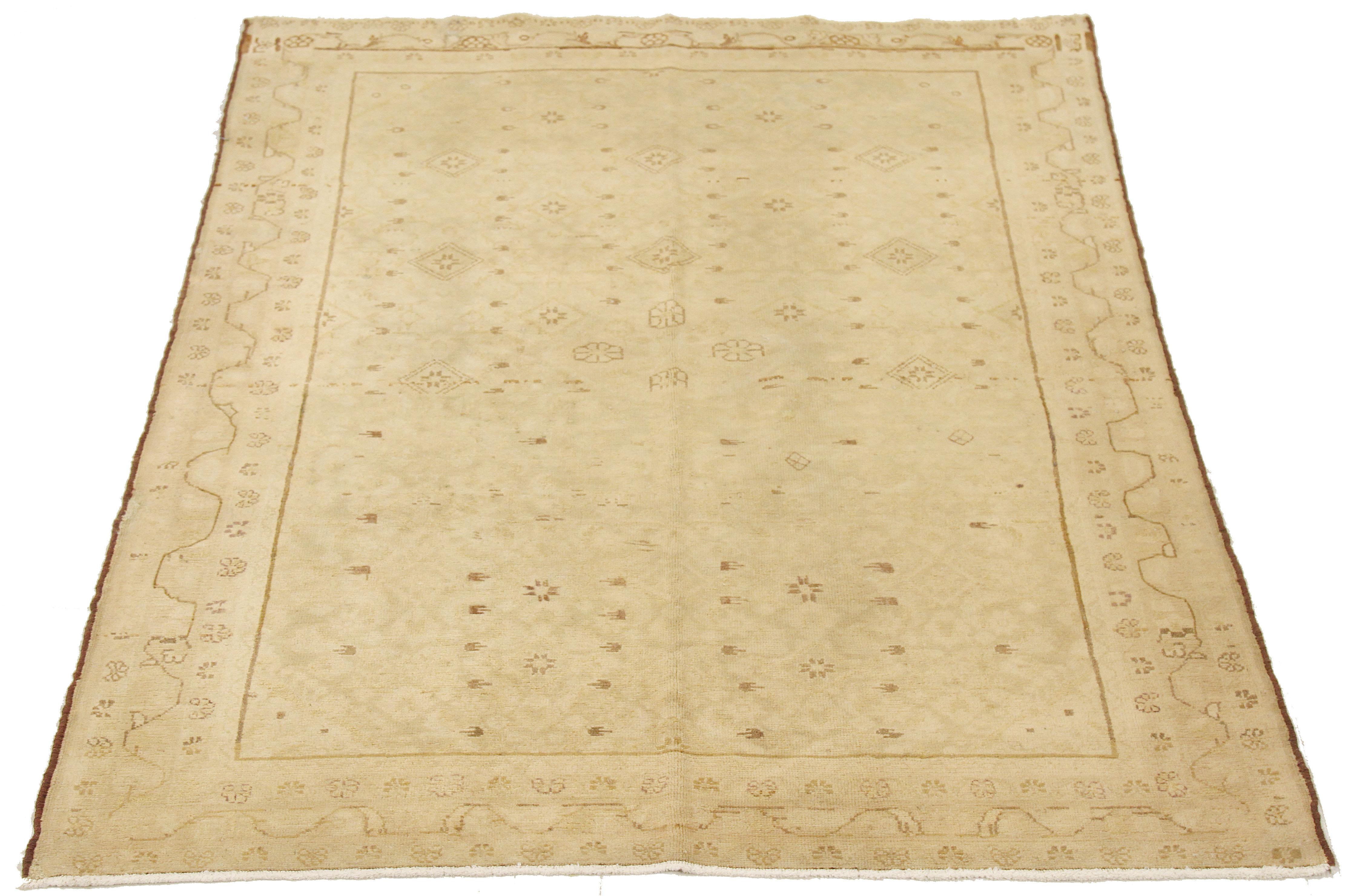 Antique Persian rug handwoven from the finest sheep’s wool and colored with all-natural vegetable dyes that are safe for humans and pets. It’s a traditional Tabriz weaving featuring a lovely ensemble of floral motifs in brown over an ivory field.