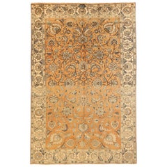 Antigua alfombra persa de Tabriz con motivos florales marrones y marfil sobre centro naranja Fie