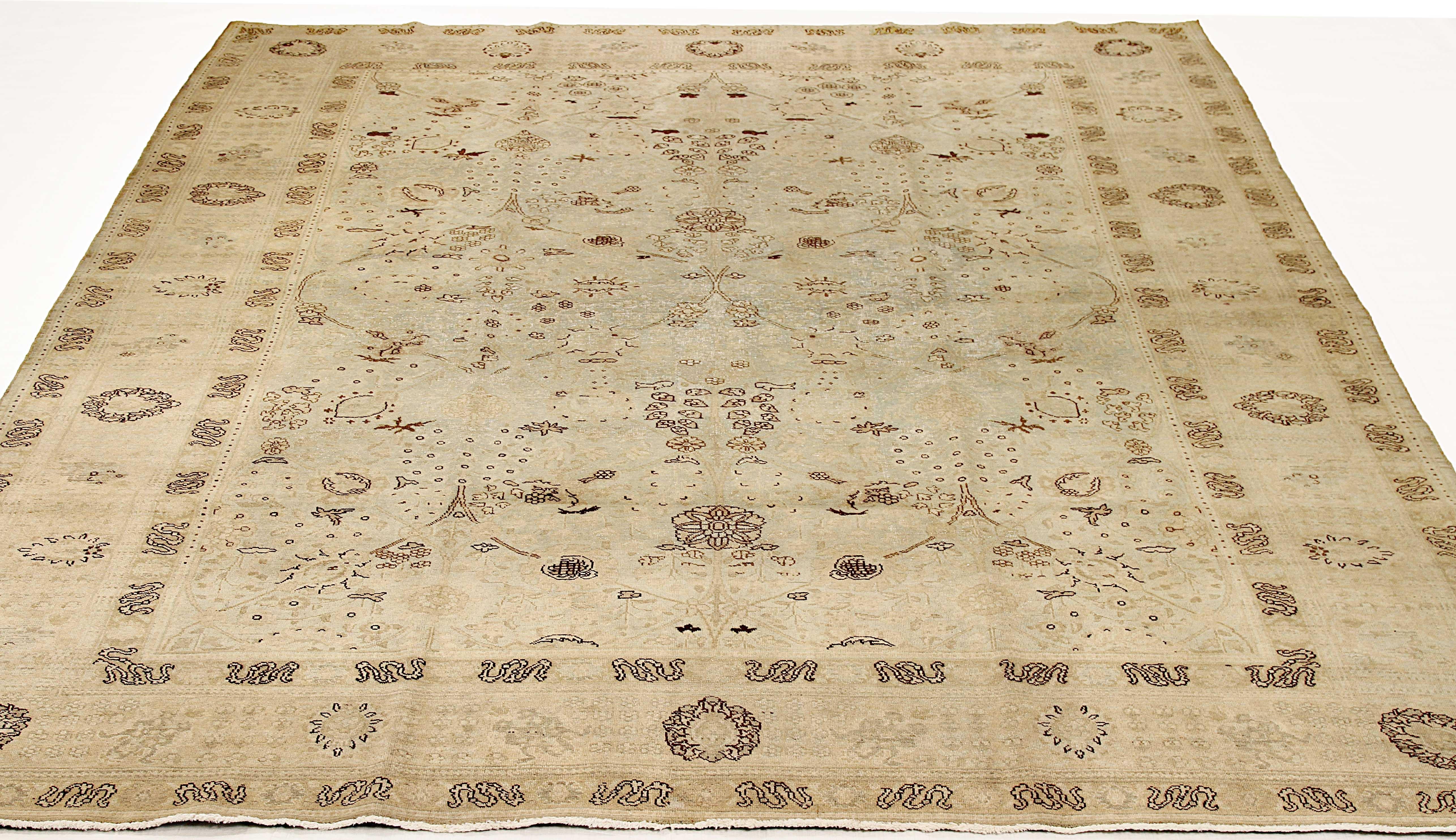 Antique Persian rug handwoven from the finest sheep’s wool and colored with all-natural vegetable dyes that are safe for humans and pets. It’s a traditional Tabriz weaving featuring a lovely ensemble of Fine floral designs in brown and black over a