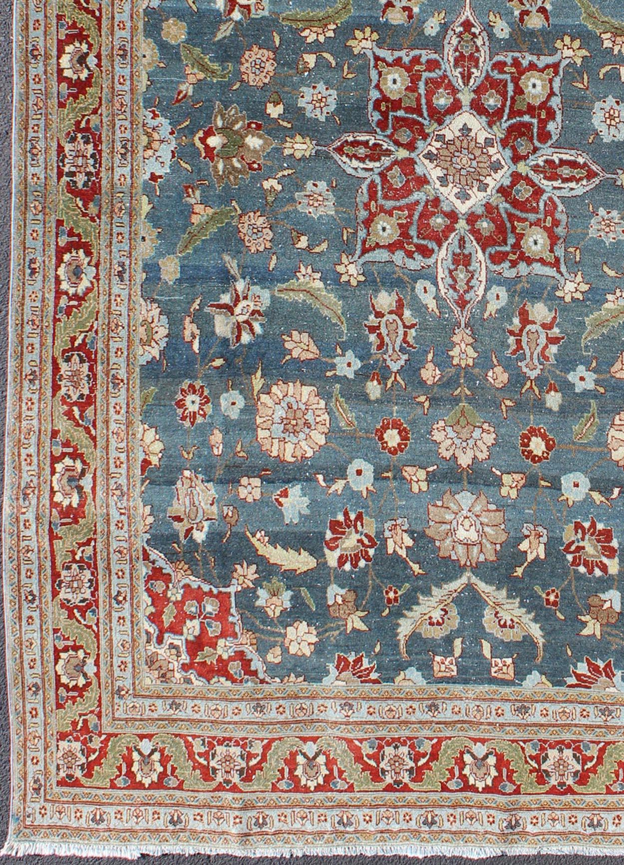 Steel blue,  antique Persian Tabriz rug with flowers and medallion, rug 18-0702, country of origin / type: Iran / Tabriz, circa 1920.

This sublime and enchanting vintage rug, a gorgeous Tabriz rug made in Iran in the early twentieth century, is a