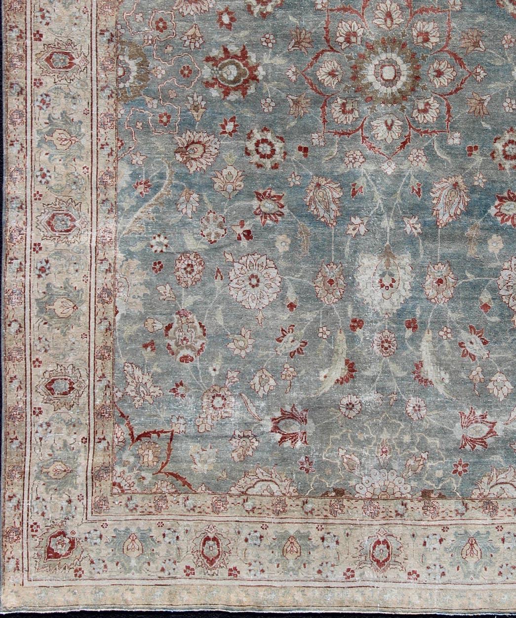 Red and blue antique Persian Tabriz rug with flowers and medallion, rug en-179642, country of origin / type: Iran / Tabriz, circa 1920.

This sublime and enchanting vintage rug, a gorgeous Tabriz rug made in Iran in the early 20th century, is a